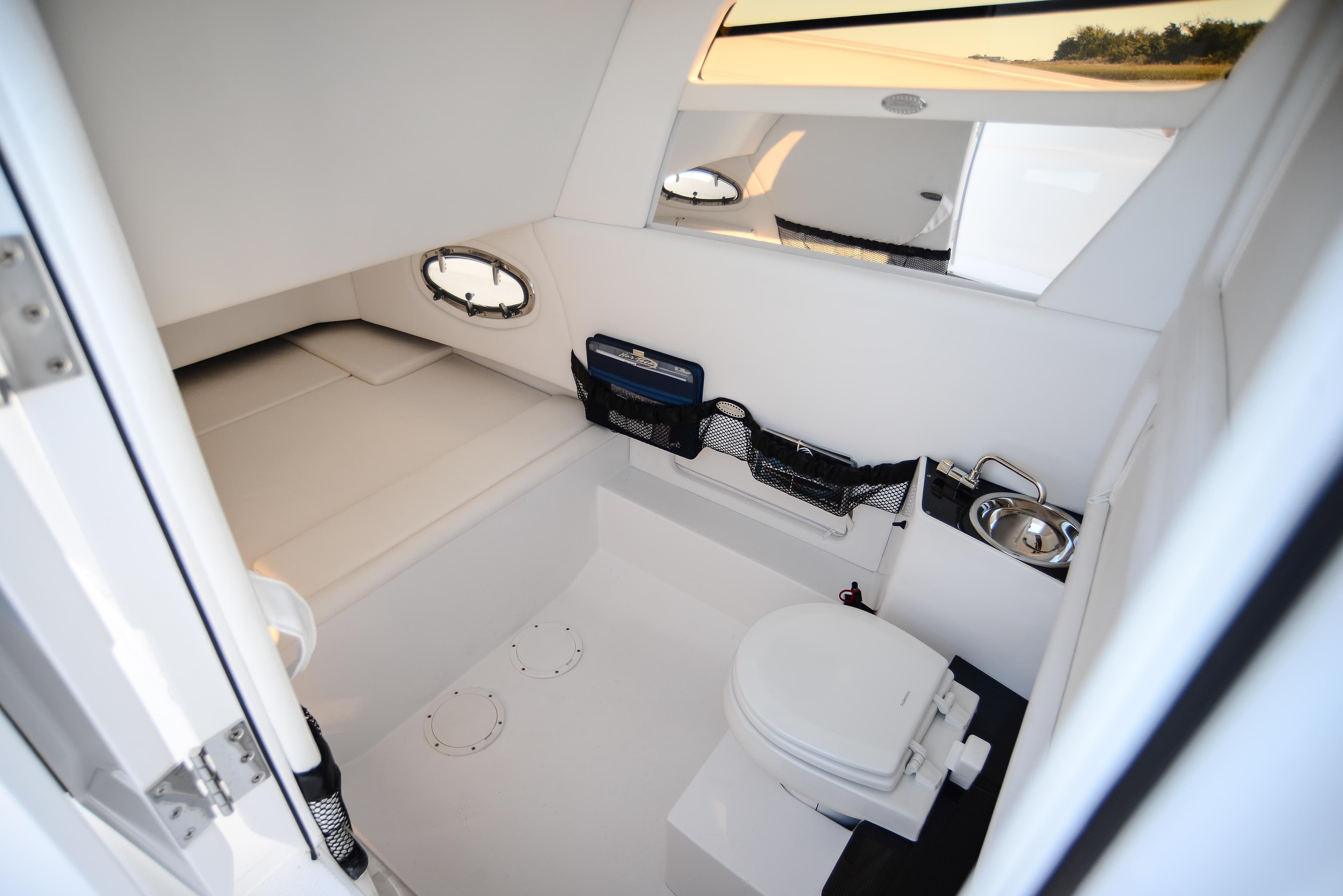 2025 Nor-Tech 340 boat interior with toilet and sink.