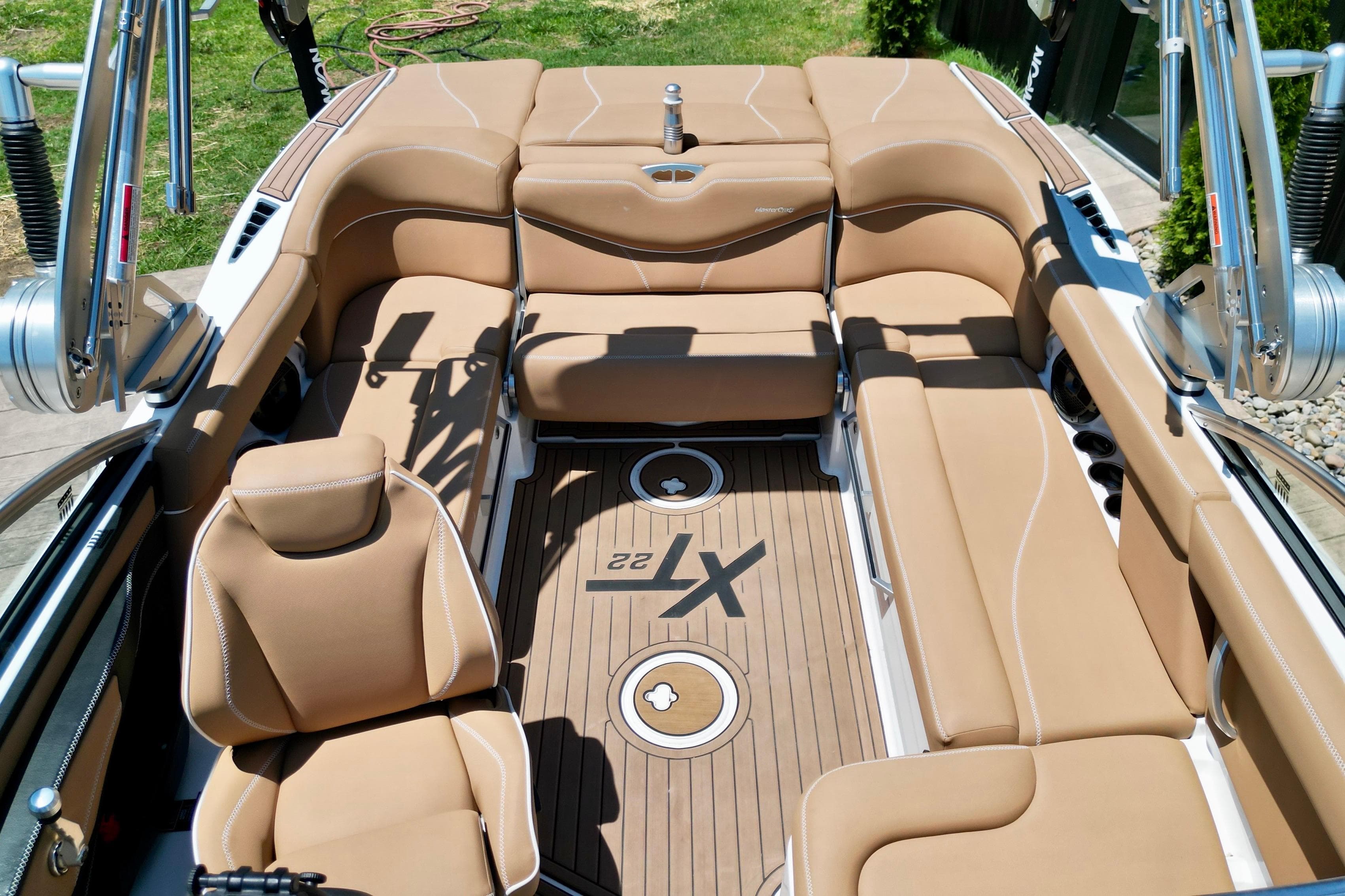 2020 MasterCraft XT22 boat interior with tan seating and teak flooring.