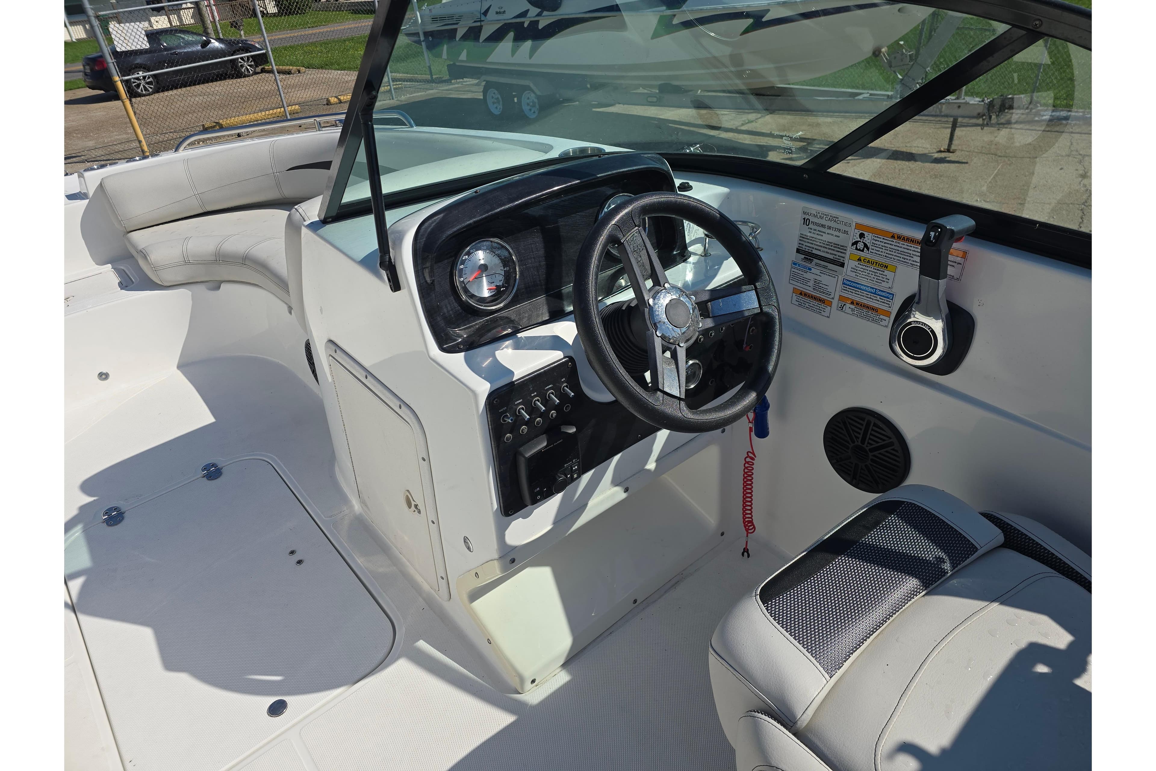2020 Hurricane SunDeck 187 OB boat interior with steering wheel and seating area.