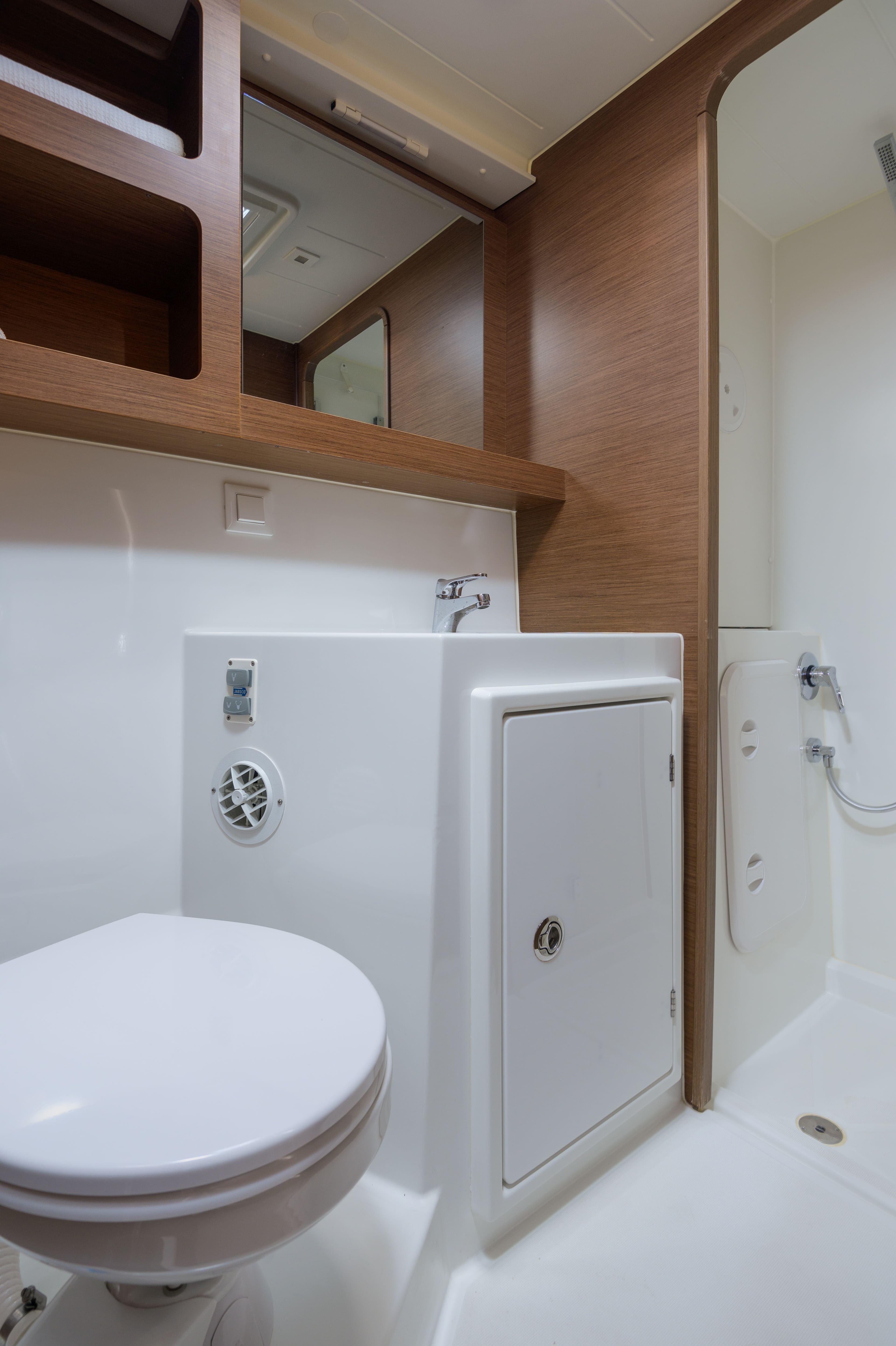 Modern bathroom in 2019 Lagoon 42 yacht with sleek fixtures and wood accents.
