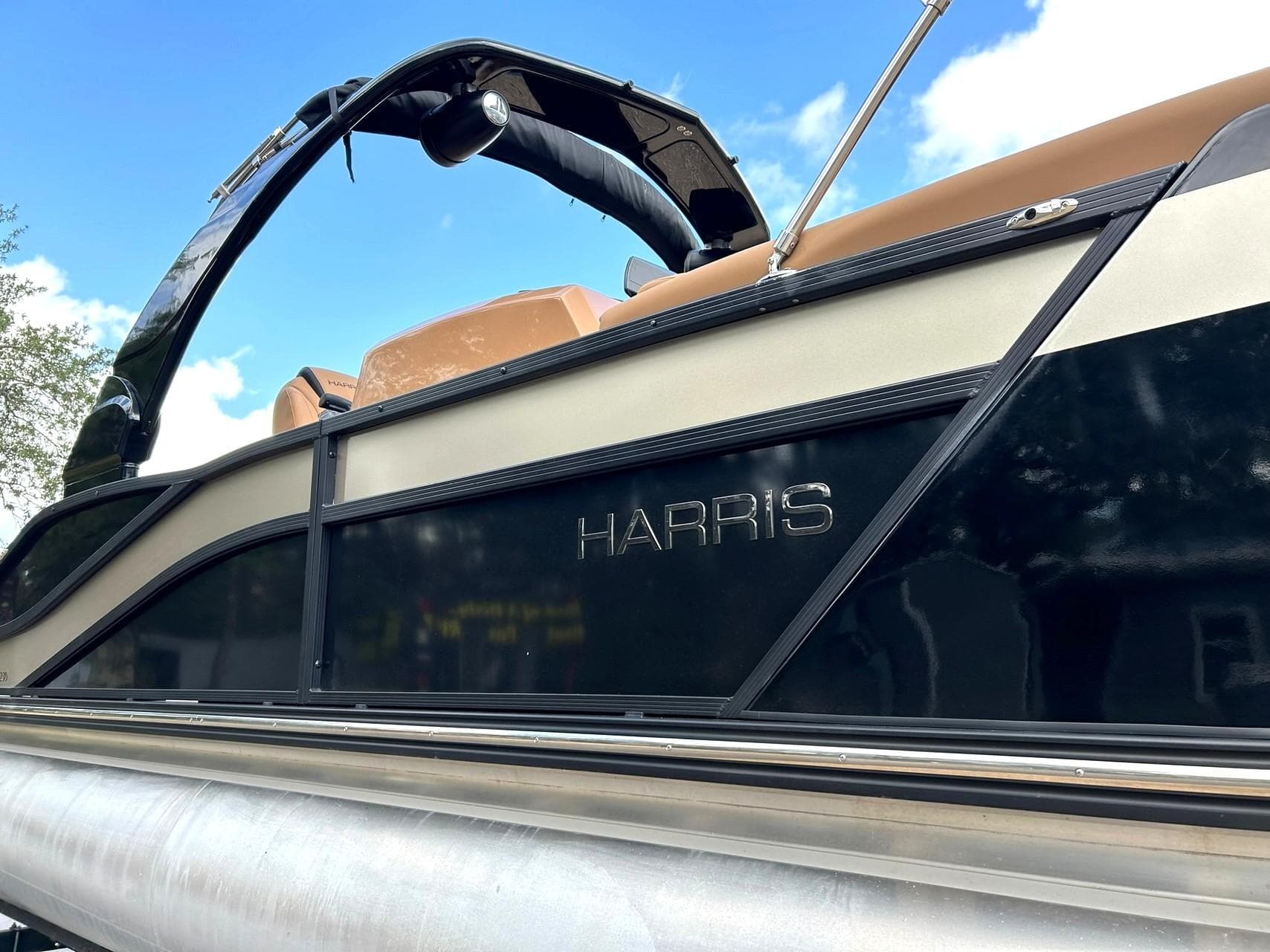 2023 Harris Grand Mariner 230 pontoon boat with sleek black and beige design.