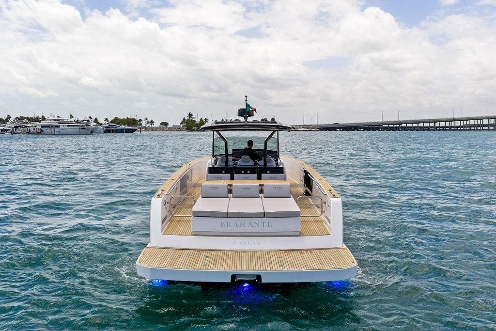 Luxury Pardo 43 yacht cruising on open water, 2021 model, with scenic marina backdrop.