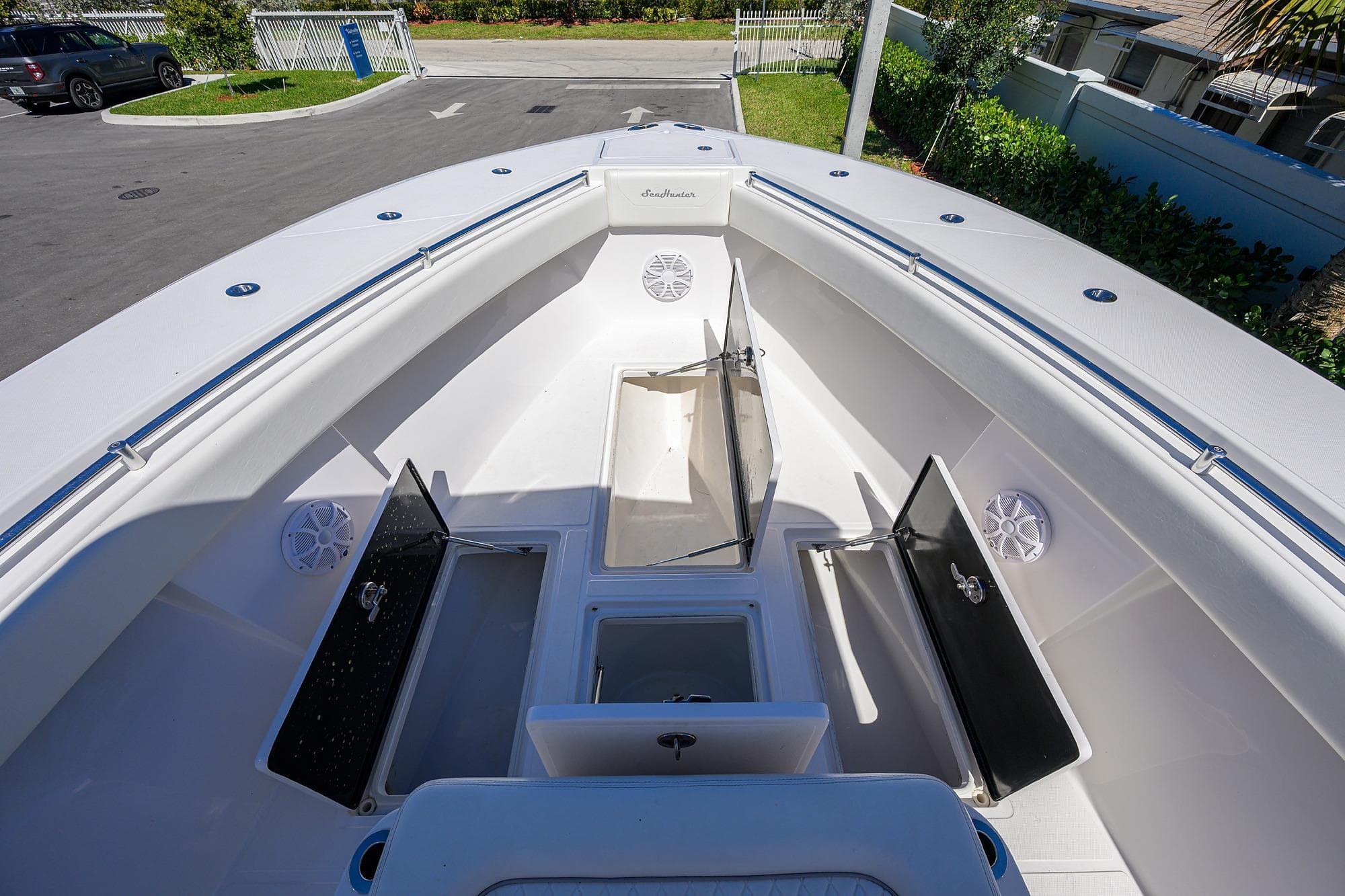2017 SeaHunter 33 Tournament boat with open storage compartments and sleek design.