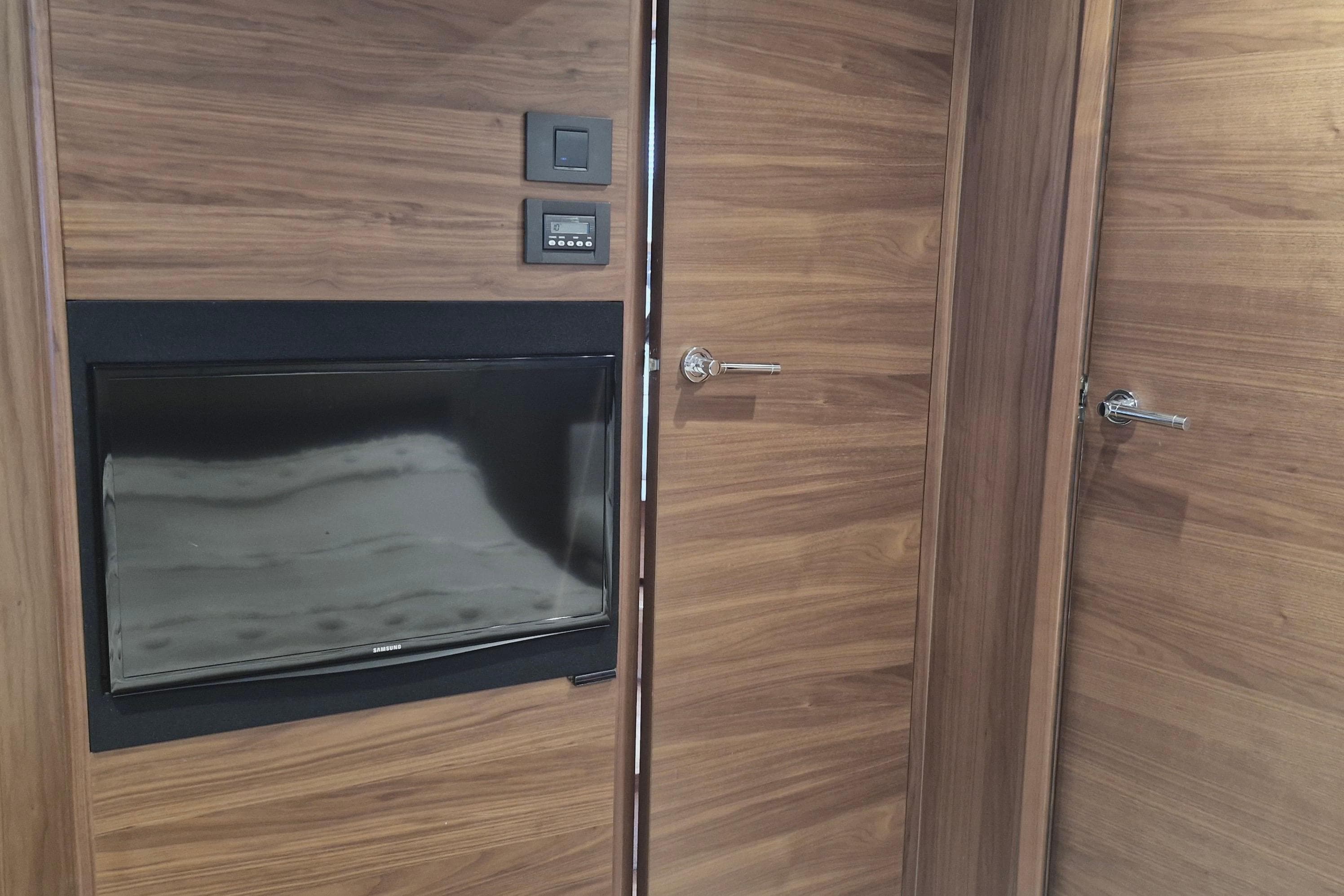 Interior of 2014 Princess V48 yacht with wood paneling and built-in TV.