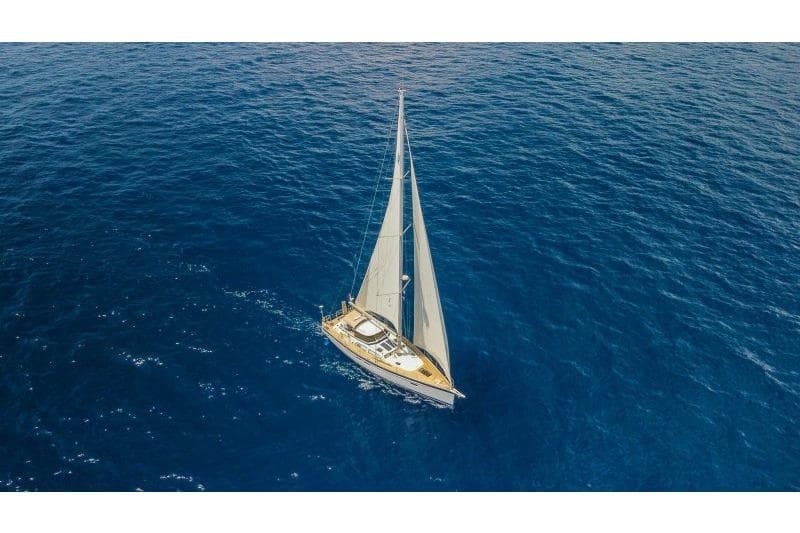 2023 Hallberg-Rassy 50 sailing yacht on open blue sea.