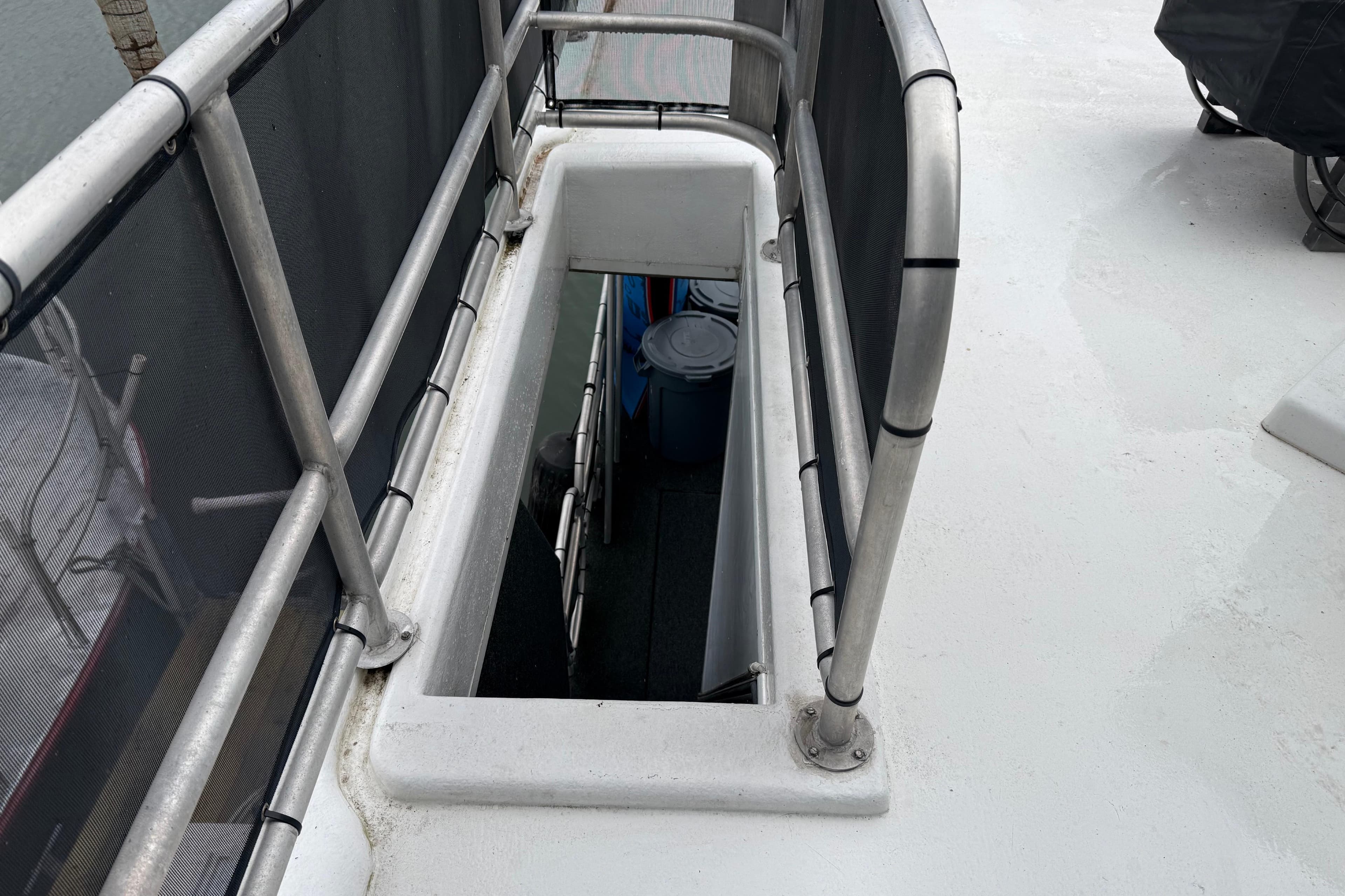Stairway on 2001 Sharpe 80 X 18 boat deck, featuring metal railings.