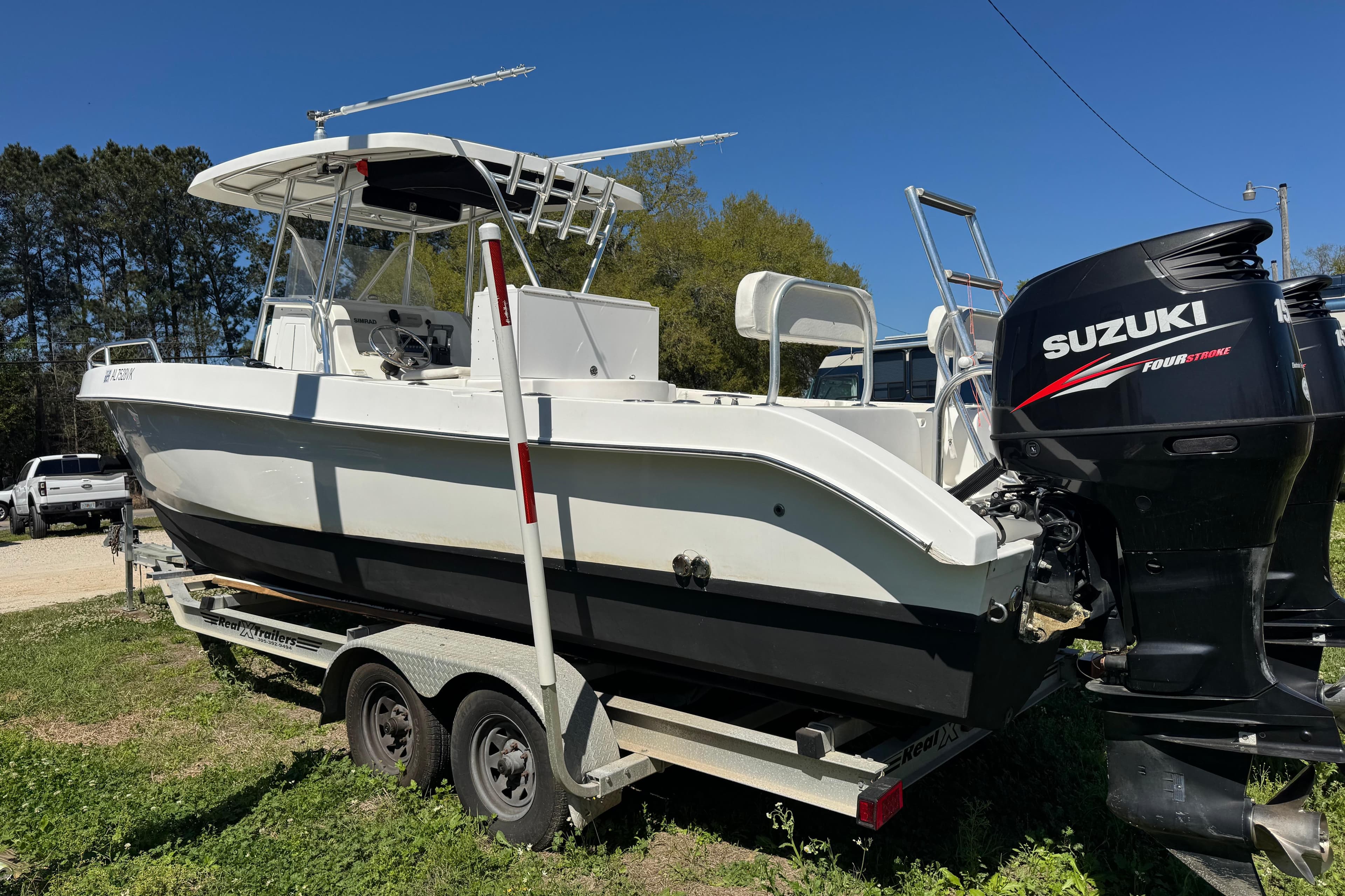 2016 Twin Vee 26 Center Console boat on trailer with Suzuki outboard motor.