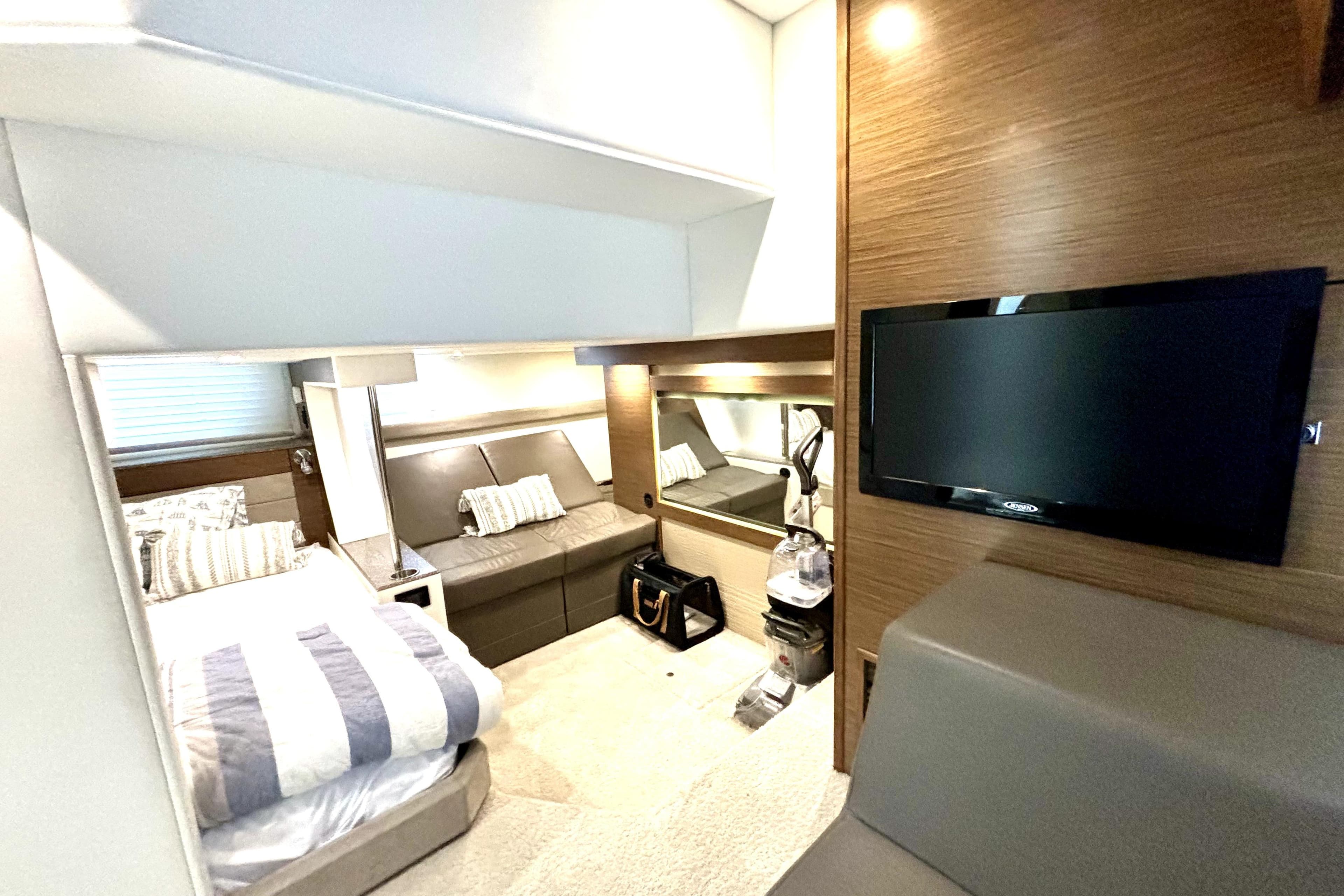 Luxurious interior of 2014 Cruisers Yachts 45 Cantius with modern furnishings and TV.