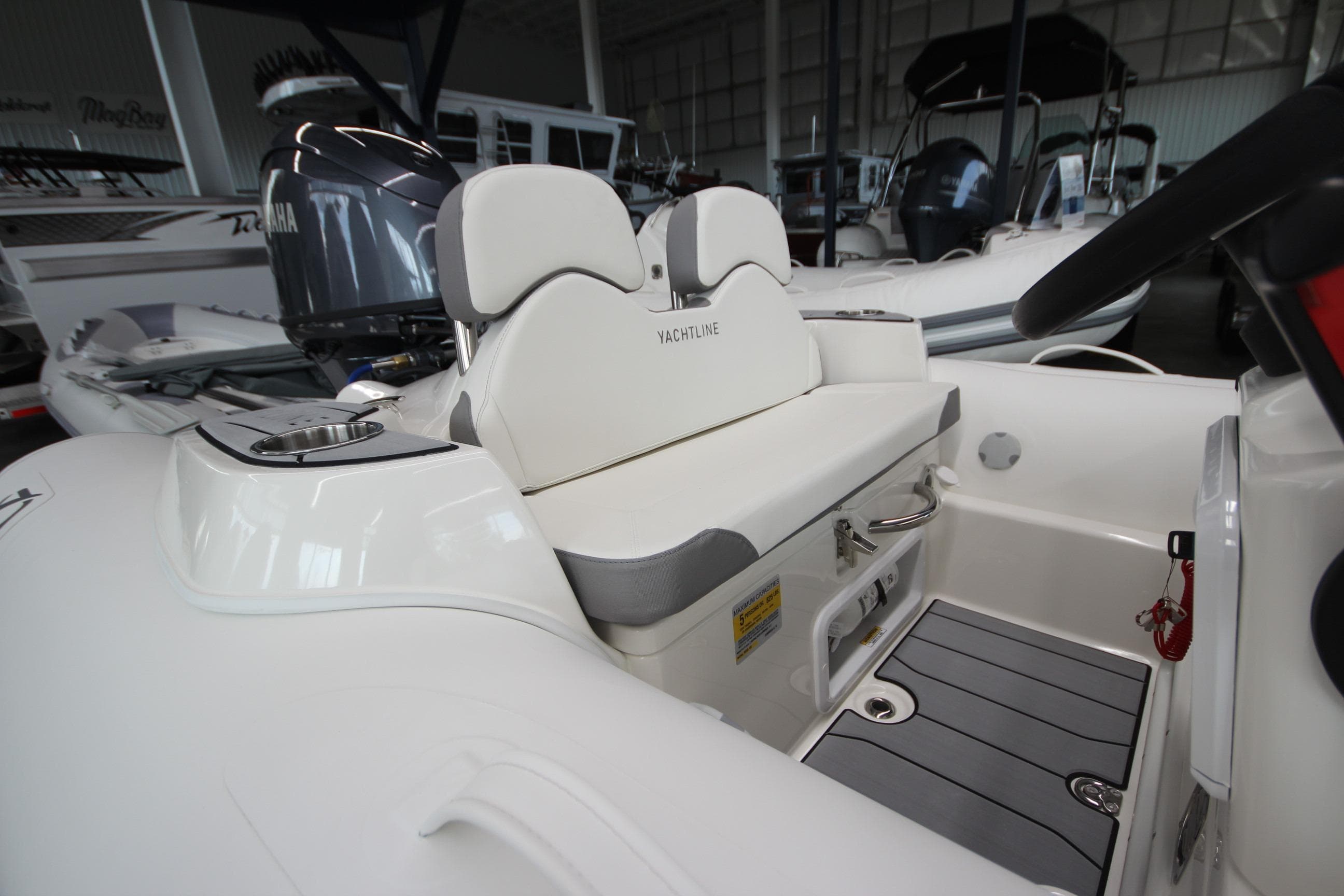 2026 Zodiac Yachtline 400 interior with seating and control panel in a showroom.