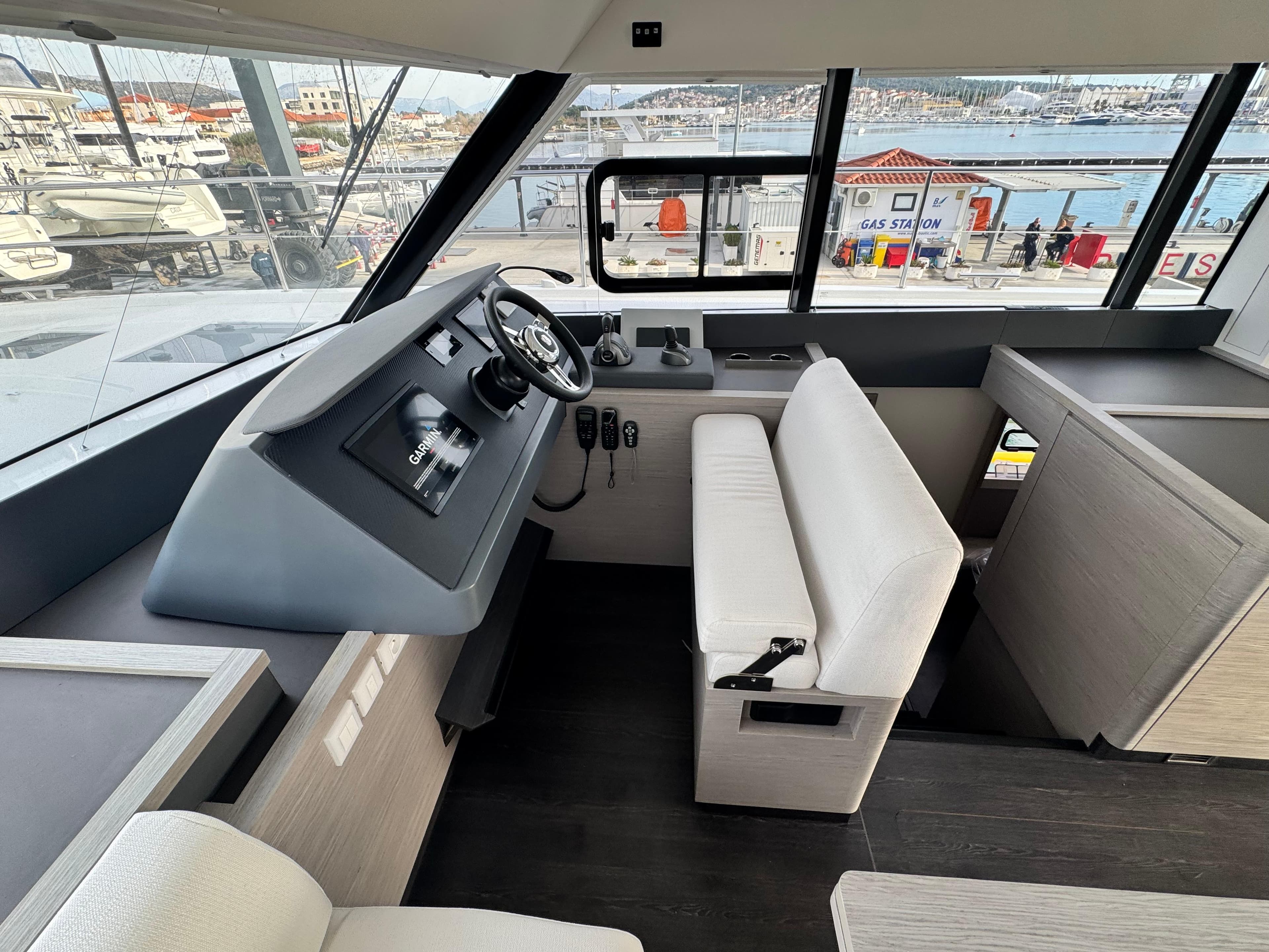 2025 Fountaine Pajot MY5 yacht interior with modern helm and panoramic windows.