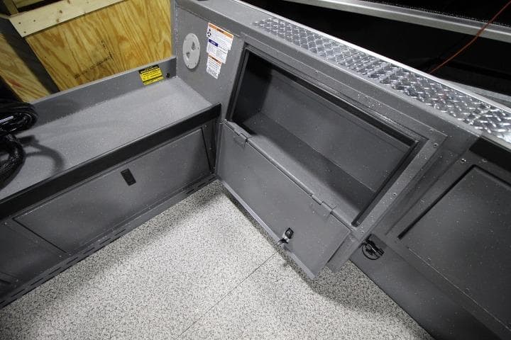 Interior of 2026 Alumaweld Columbia 21 boat showing storage compartments and non-slip flooring.