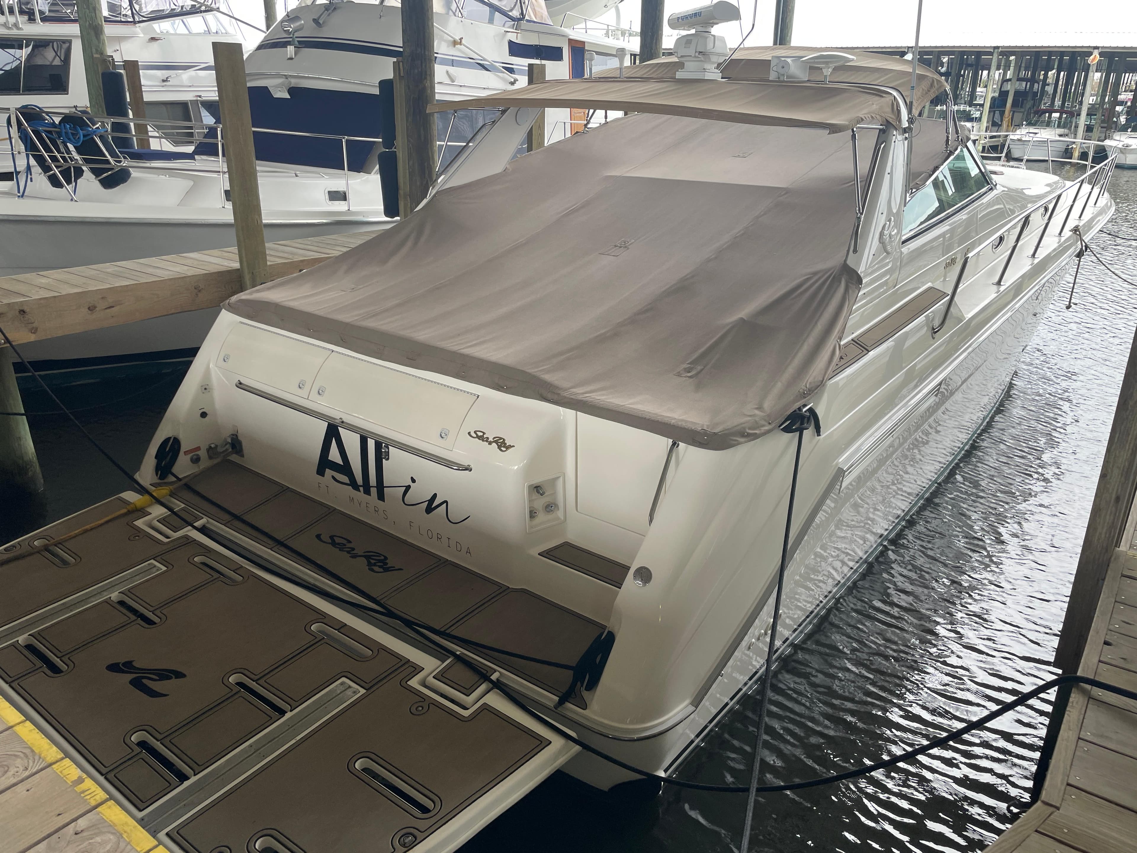 1996 Sea Ray 500 Sundancer docked, covered, rear view.