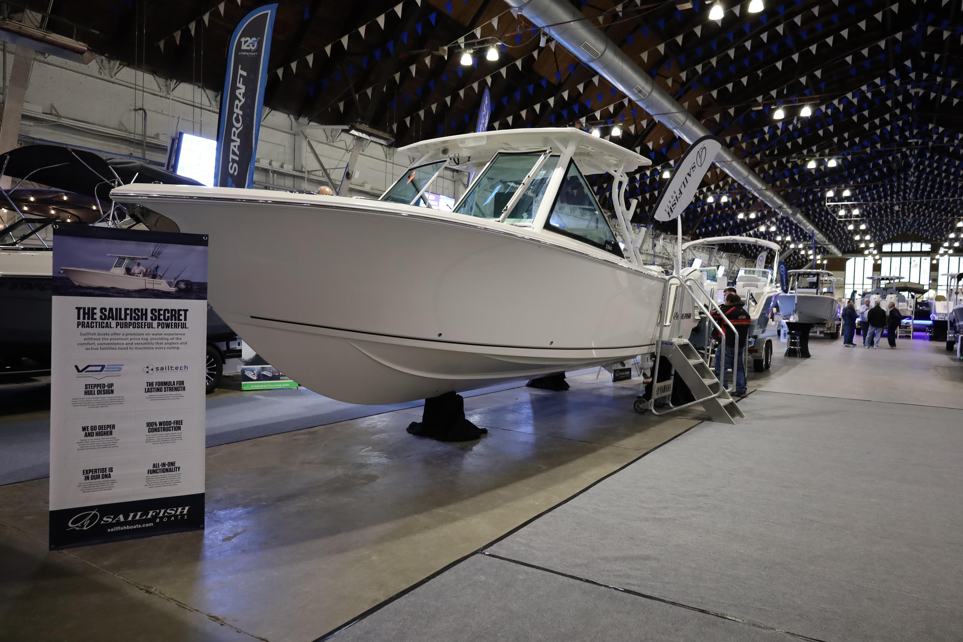 2025 Sailfish 276 DC boat displayed at an indoor exhibition, showcasing its sleek design.
