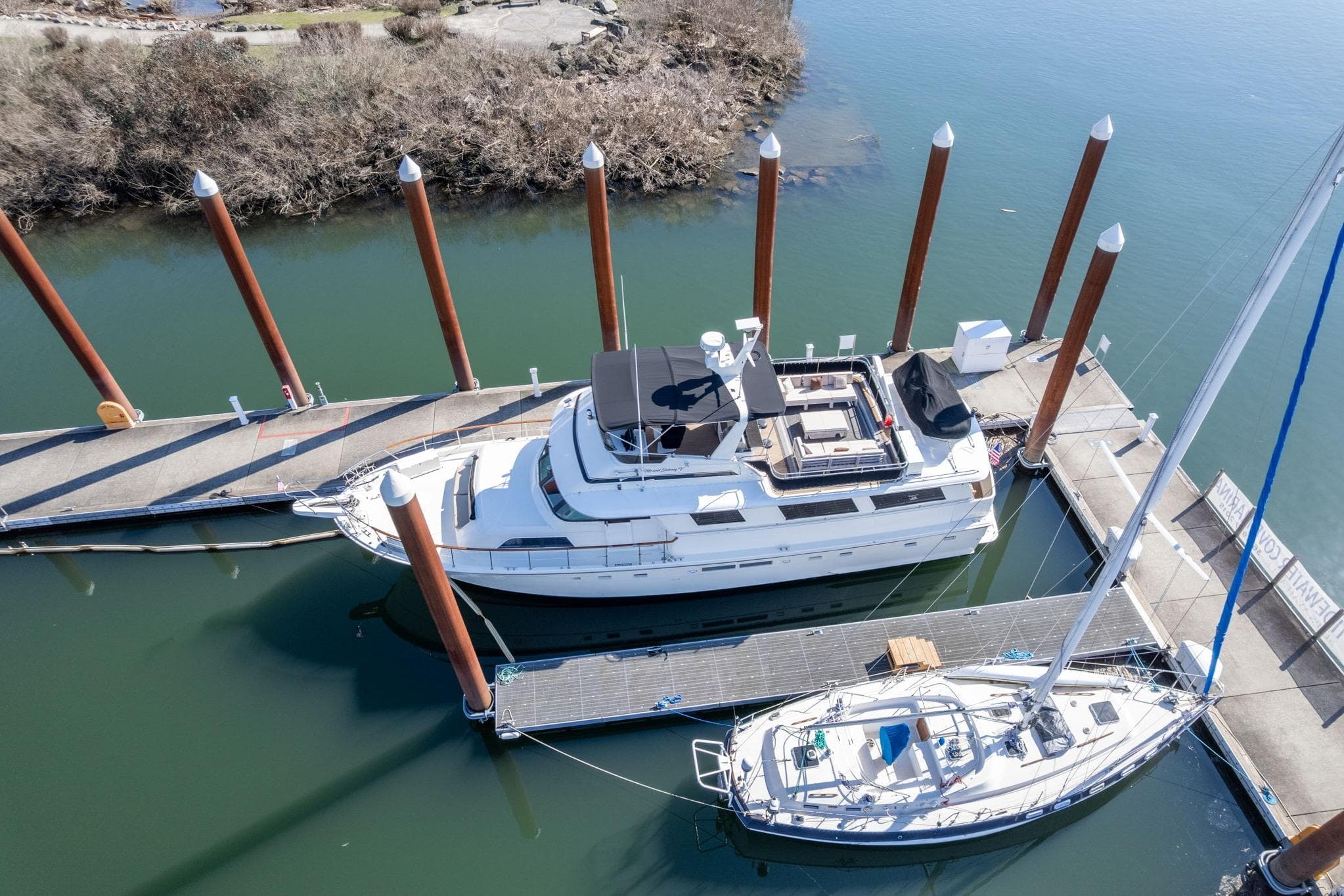 1986 Hatteras 63 Motor Yacht docked at marina, aerial view.