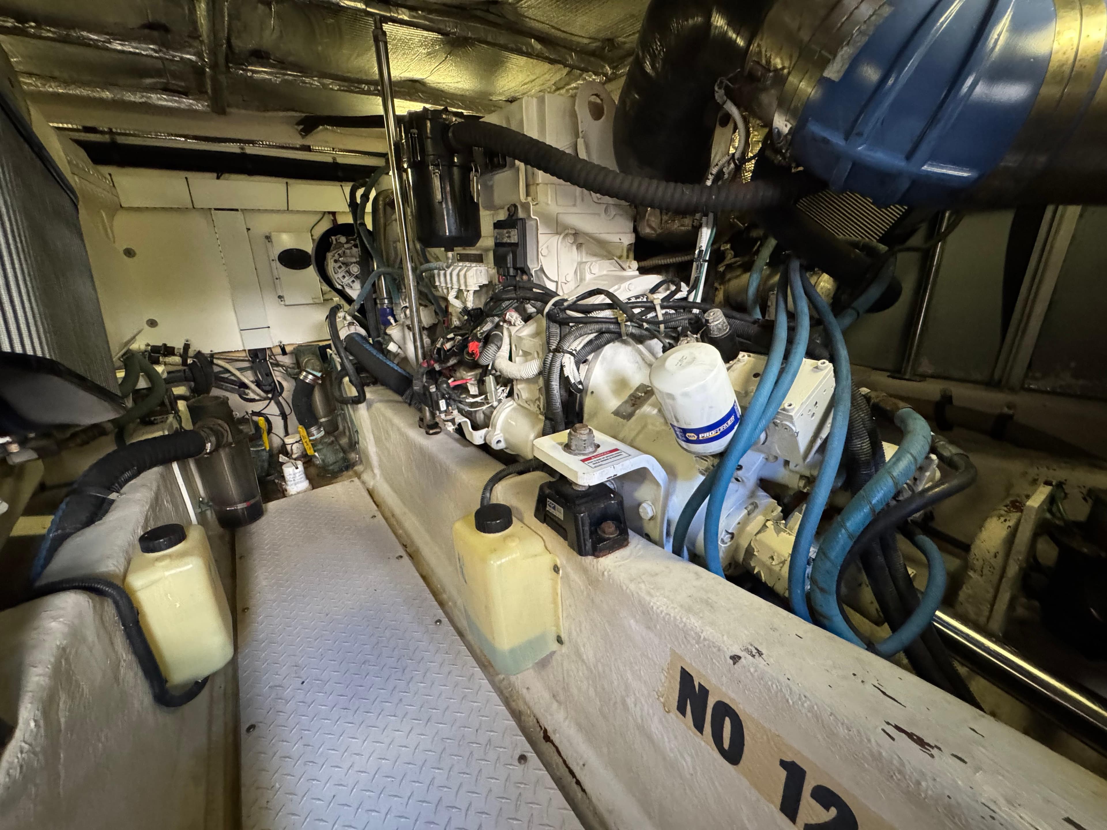 Engine room of a 2007 Sea Ray 52 Sedan Bridge with visible machinery and components.