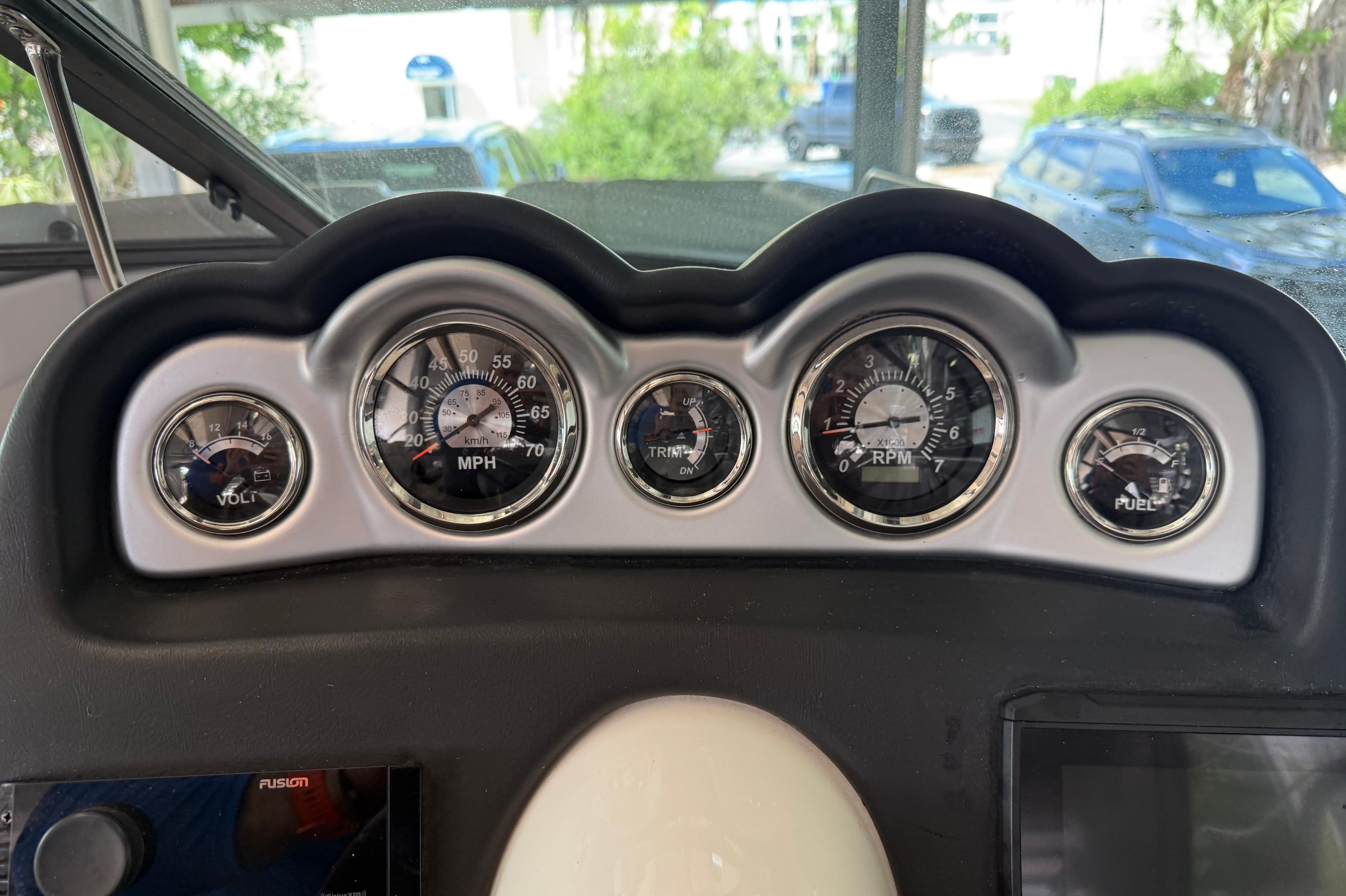 Dashboard of 2023 NauticStar 243 DC boat with speedometer, tachometer, and fuel gauges.