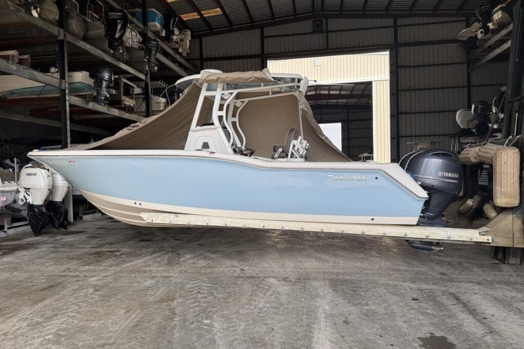 2018 Tidewater 252 CC Adventure boat in storage with Yamaha outboard motor.