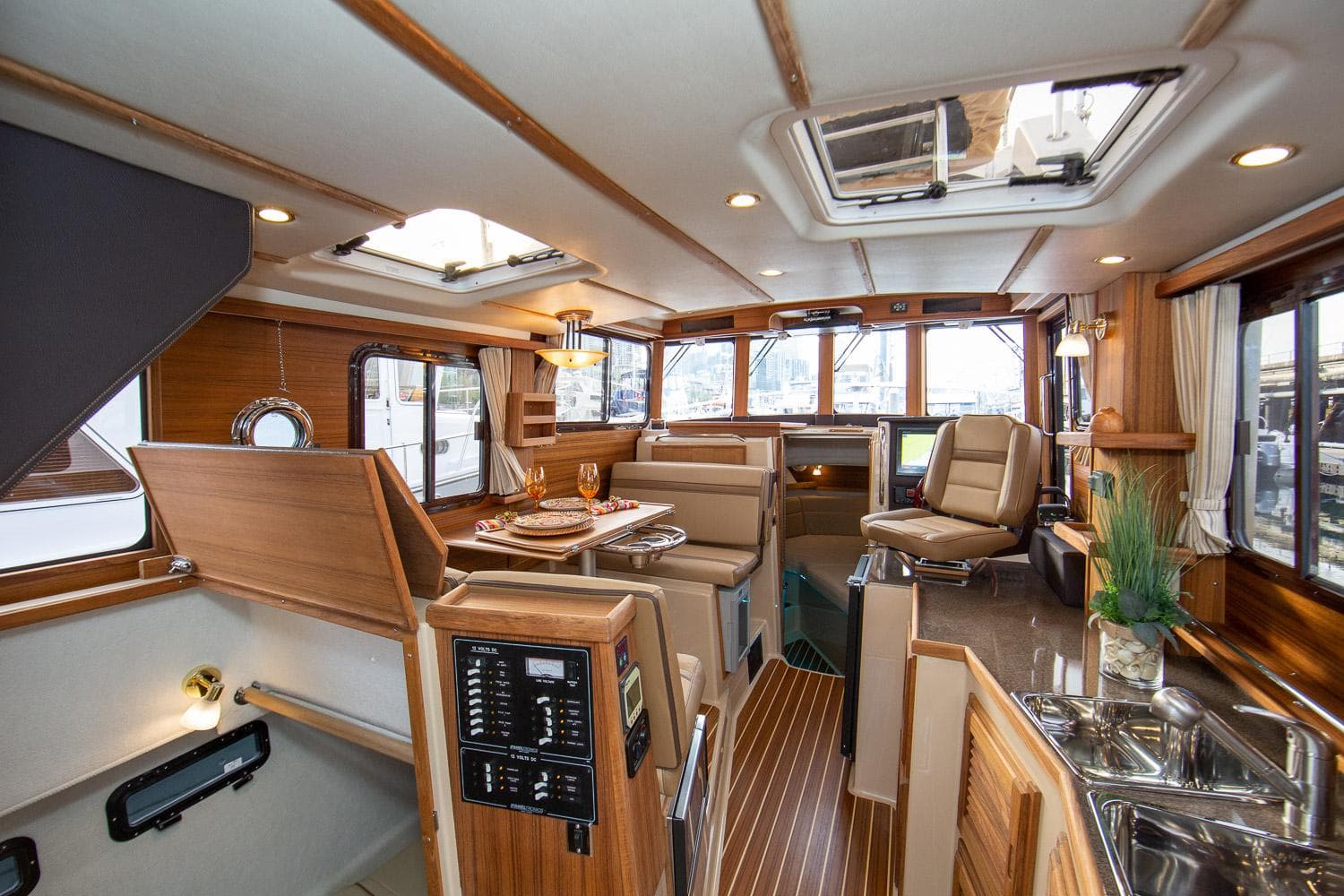 Manufacturer Provided Image: Luxurious interior of 2025 Ranger Tugs R-31 CB yacht with wood finishes and modern amenities.