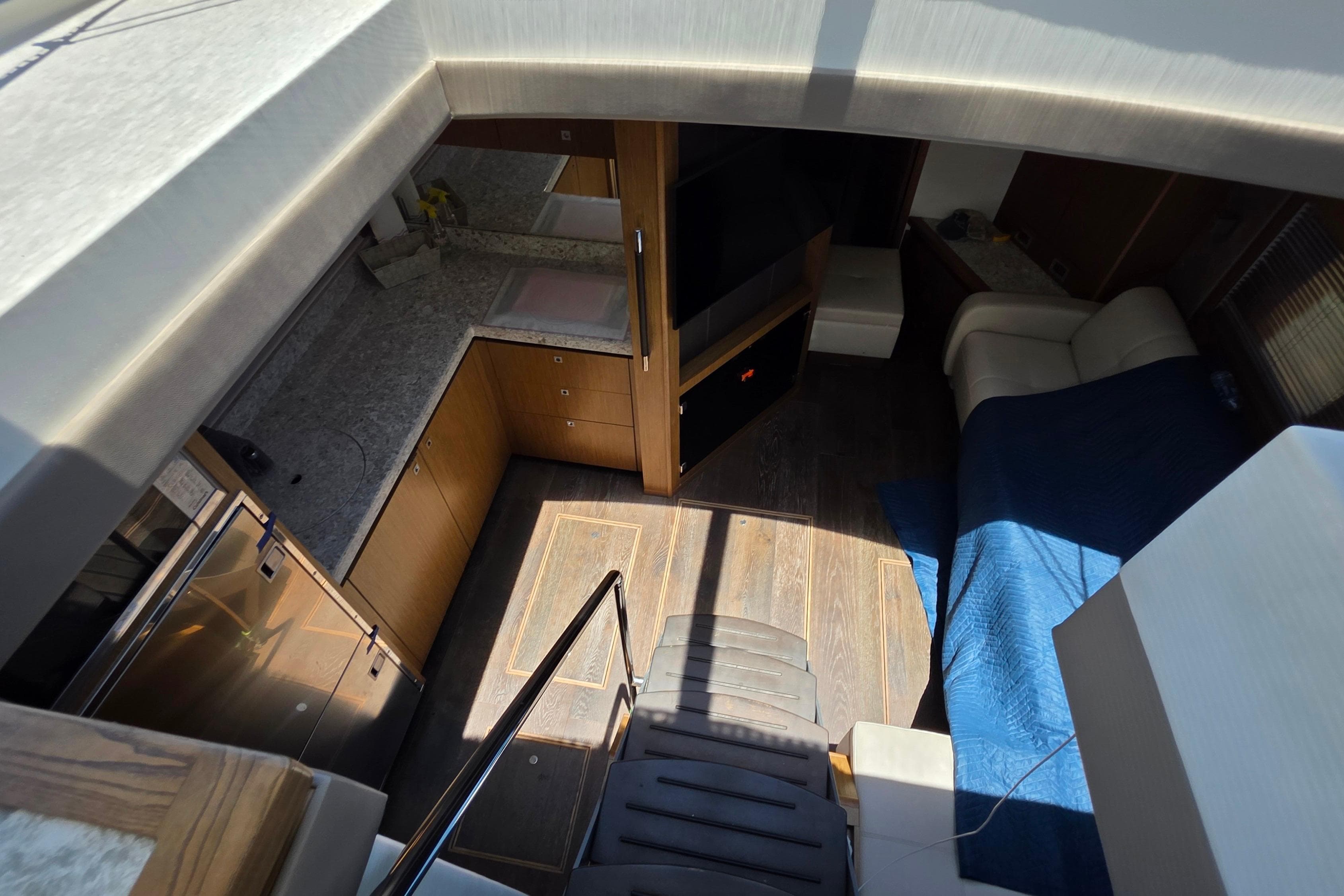 Interior view of 2018 Sea Ray Sundancer 510 yacht, featuring modern kitchen and cozy seating area.
