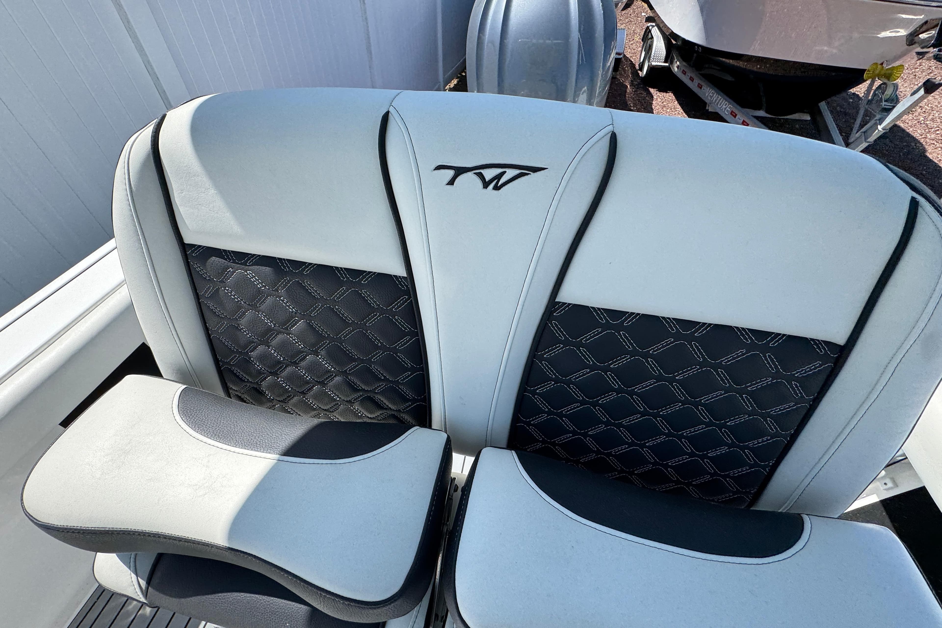 2022 Tidewater 232 SS boat seat with stylish black and white upholstery design.