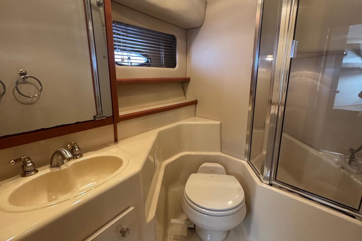 Bathroom interior of 2004 Meridian 490 Pilothouse yacht with sink, toilet, and shower.