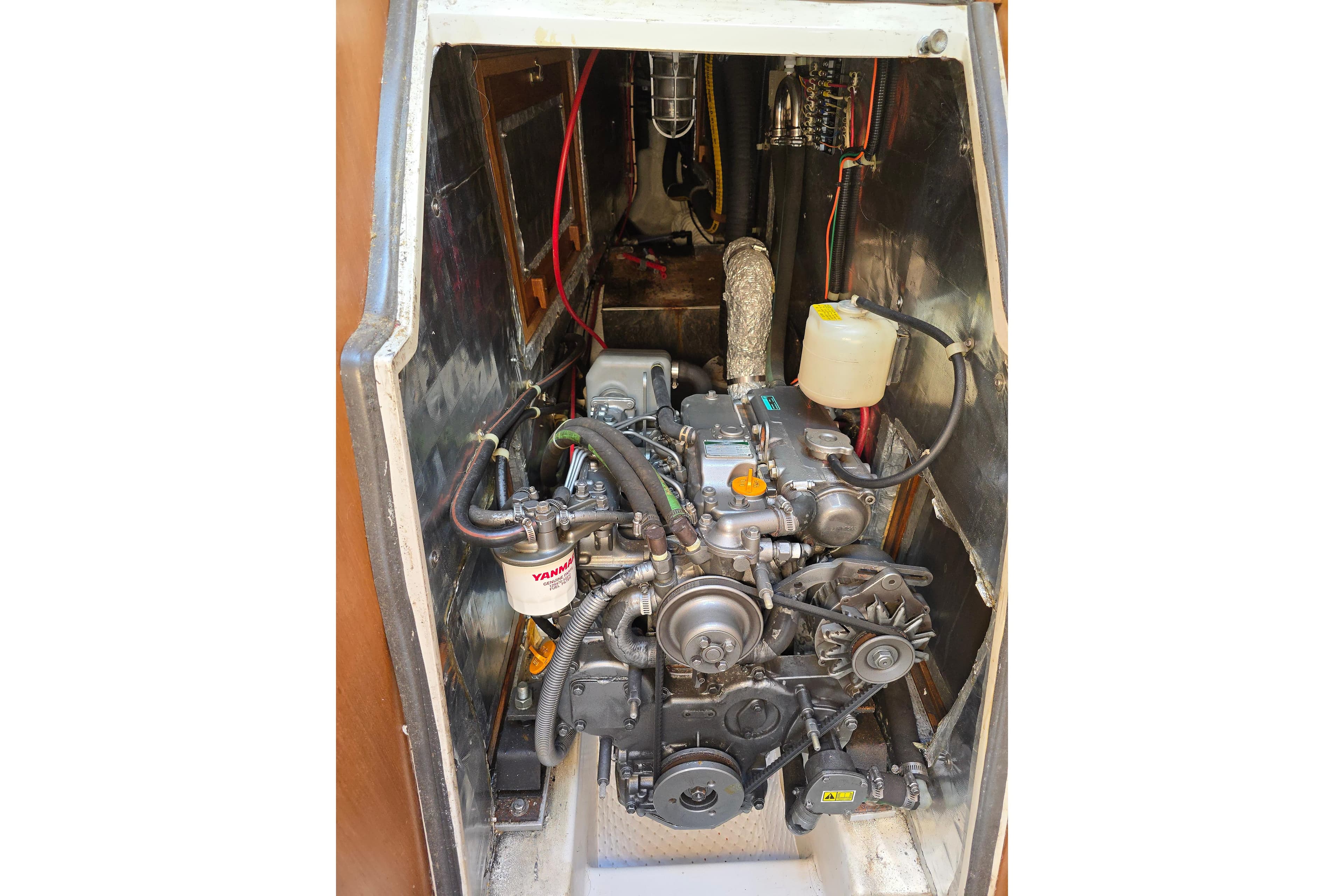 Engine compartment of a 1993 Catalina 42 sailboat, featuring a Yanmar diesel engine.