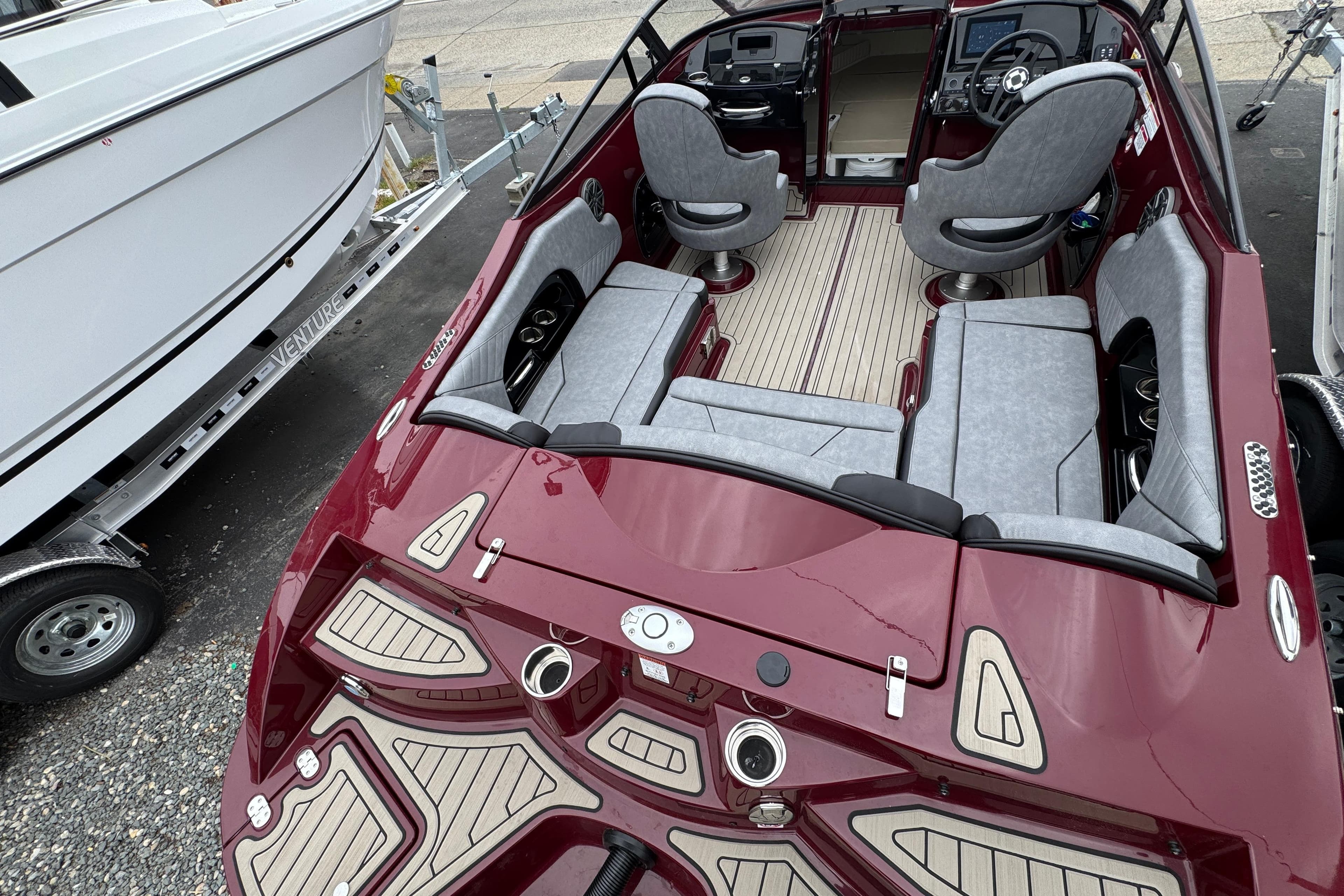 2026 Stingray 23 OCX boat with sleek maroon design and luxurious seating.