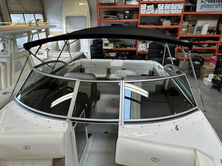 2011 Cobalt 296 boat with black canopy in a storage facility.