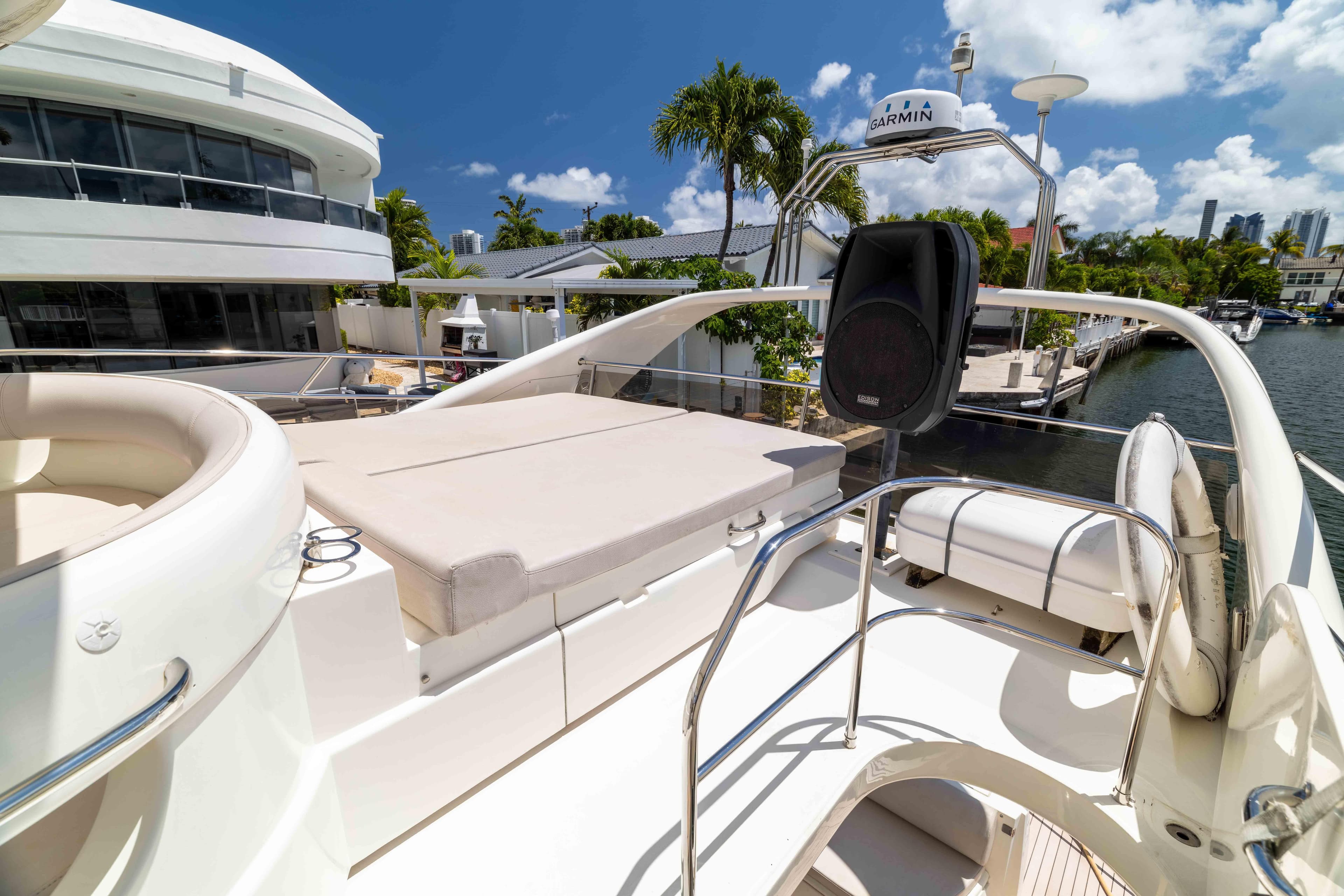 Luxurious 2002 Princess 61 yacht deck with seating, speaker, and waterway view.