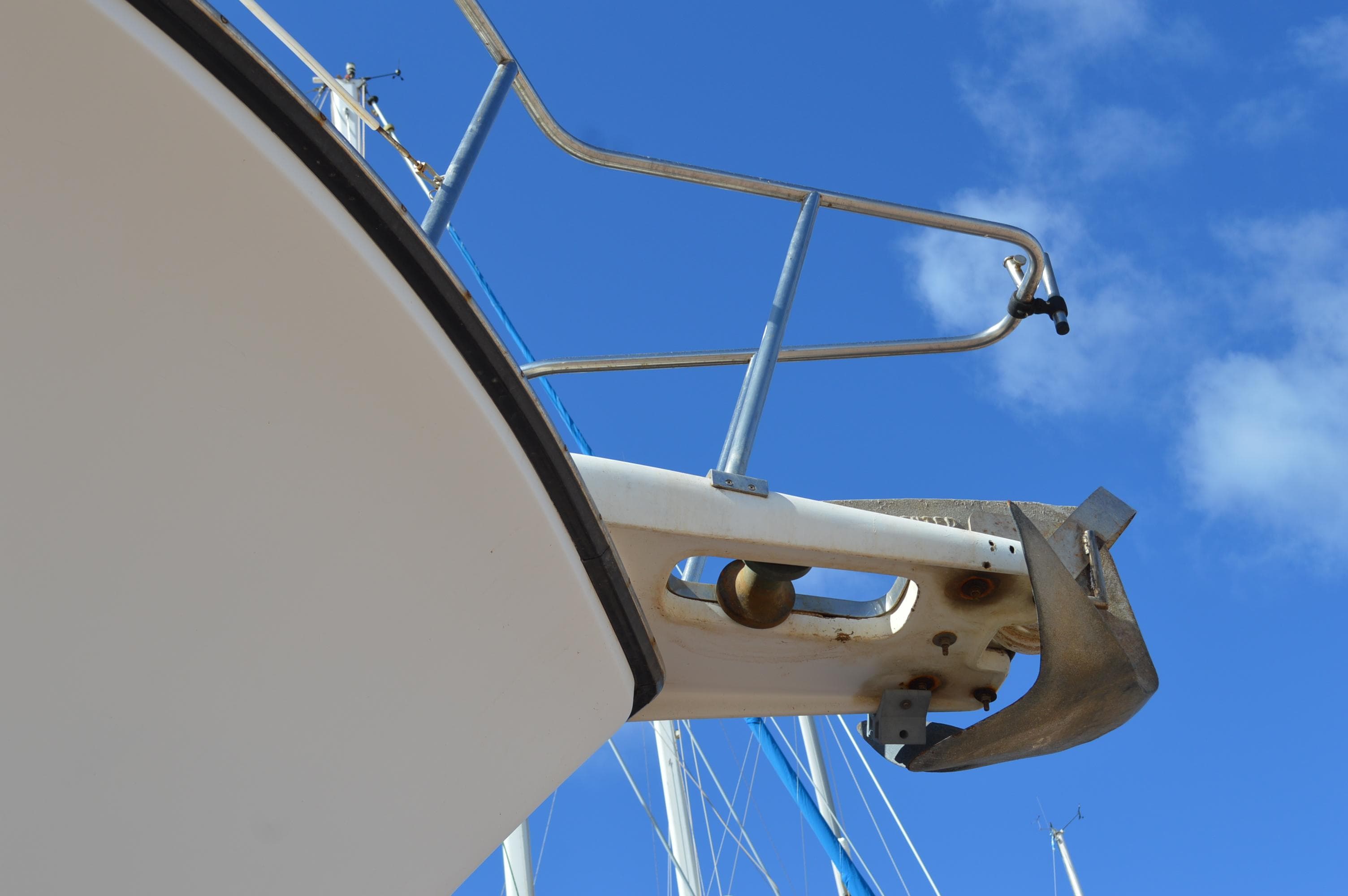 Bow of a 1987 Symbol 51 yacht against a clear blue sky.