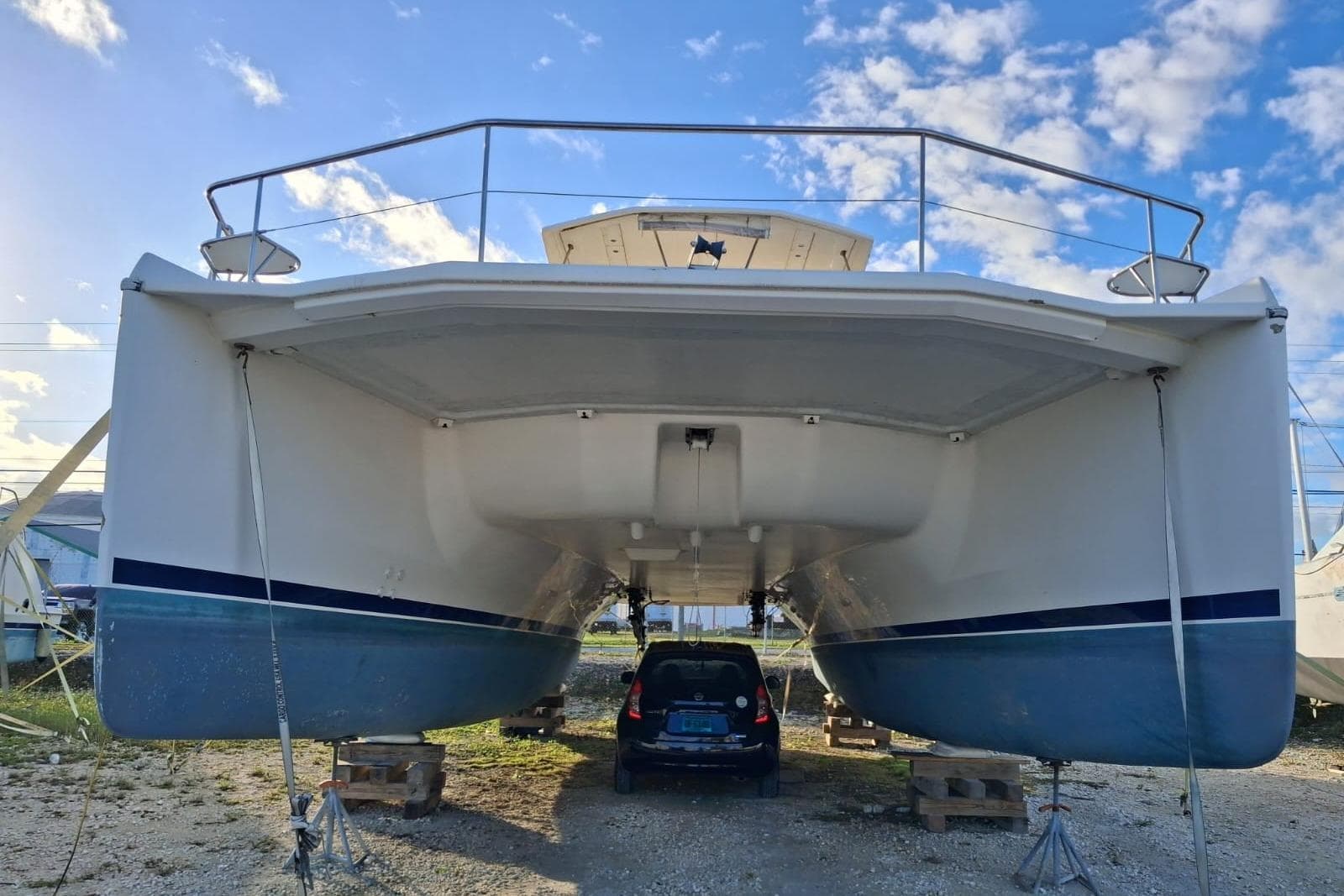 2015 Leopard 51 Powercat catamaran on stands, with a car parked underneath.