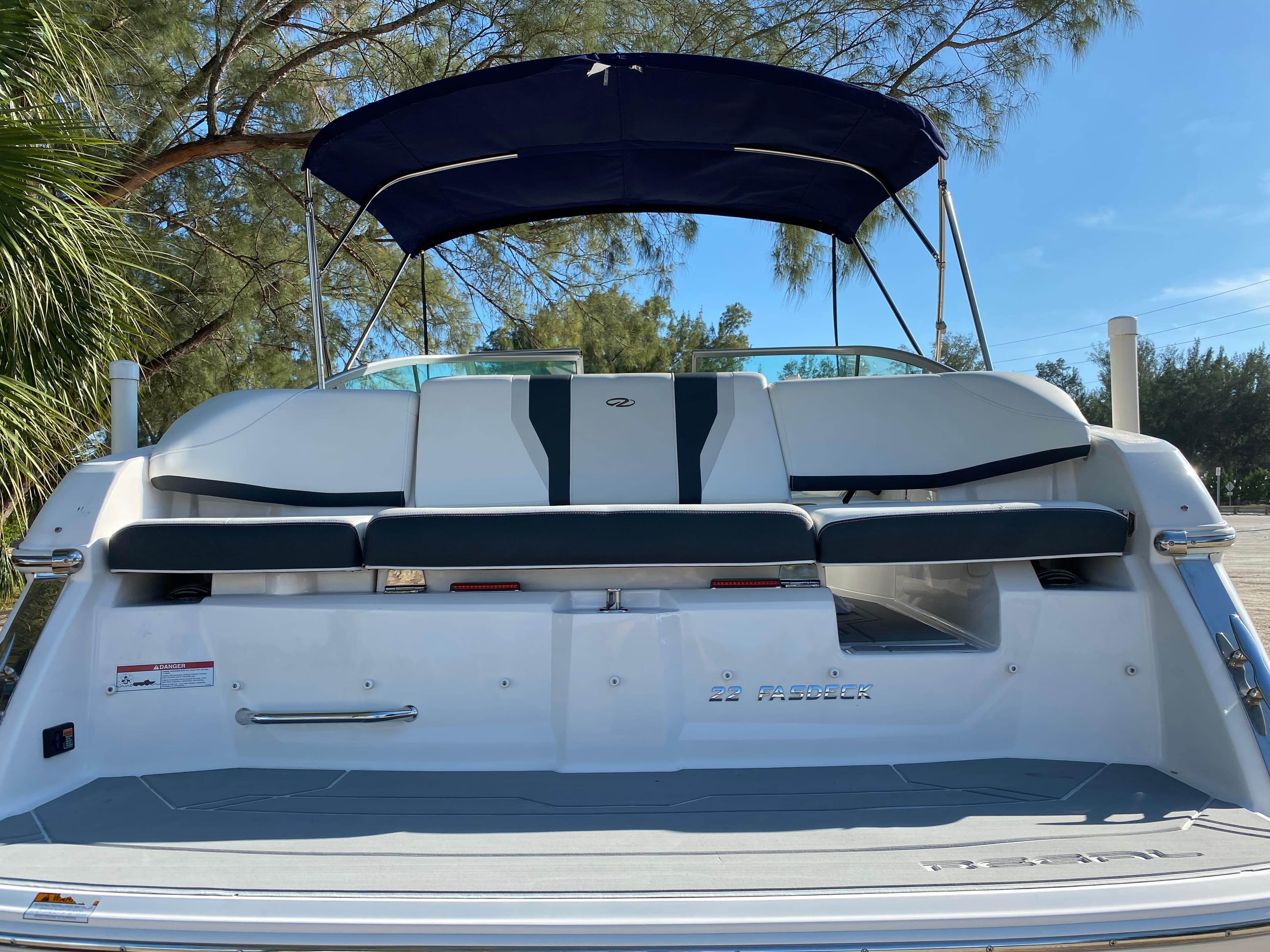 2017 Regal 22 FasDeck boat with rear seating and canopy.