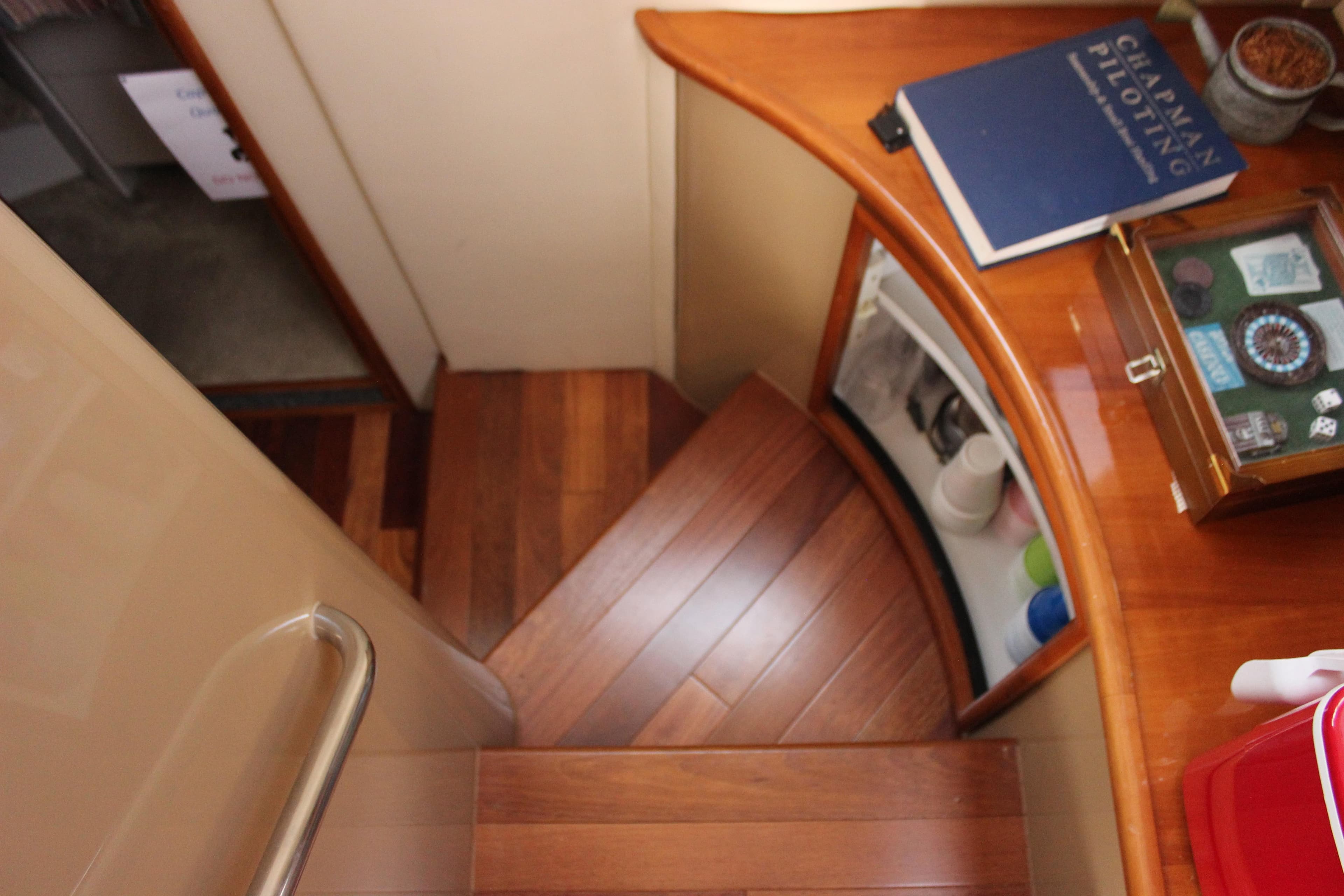 Interior of 2003 Carver 36 Super Sport yacht with wooden stairs and navigation book.