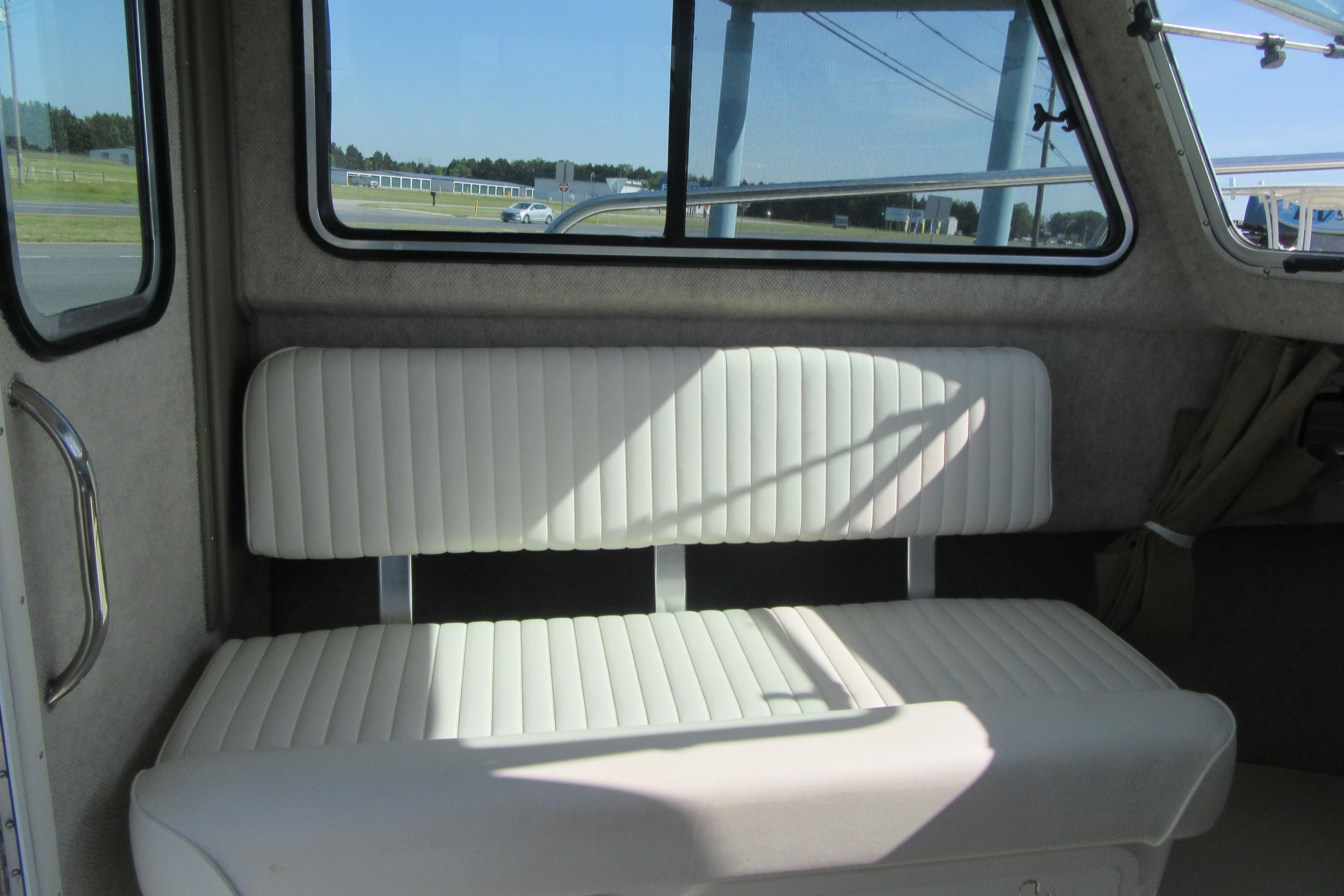 Interior of 2013 Parker 2320 SL Sport Cabin with white cushioned seating.