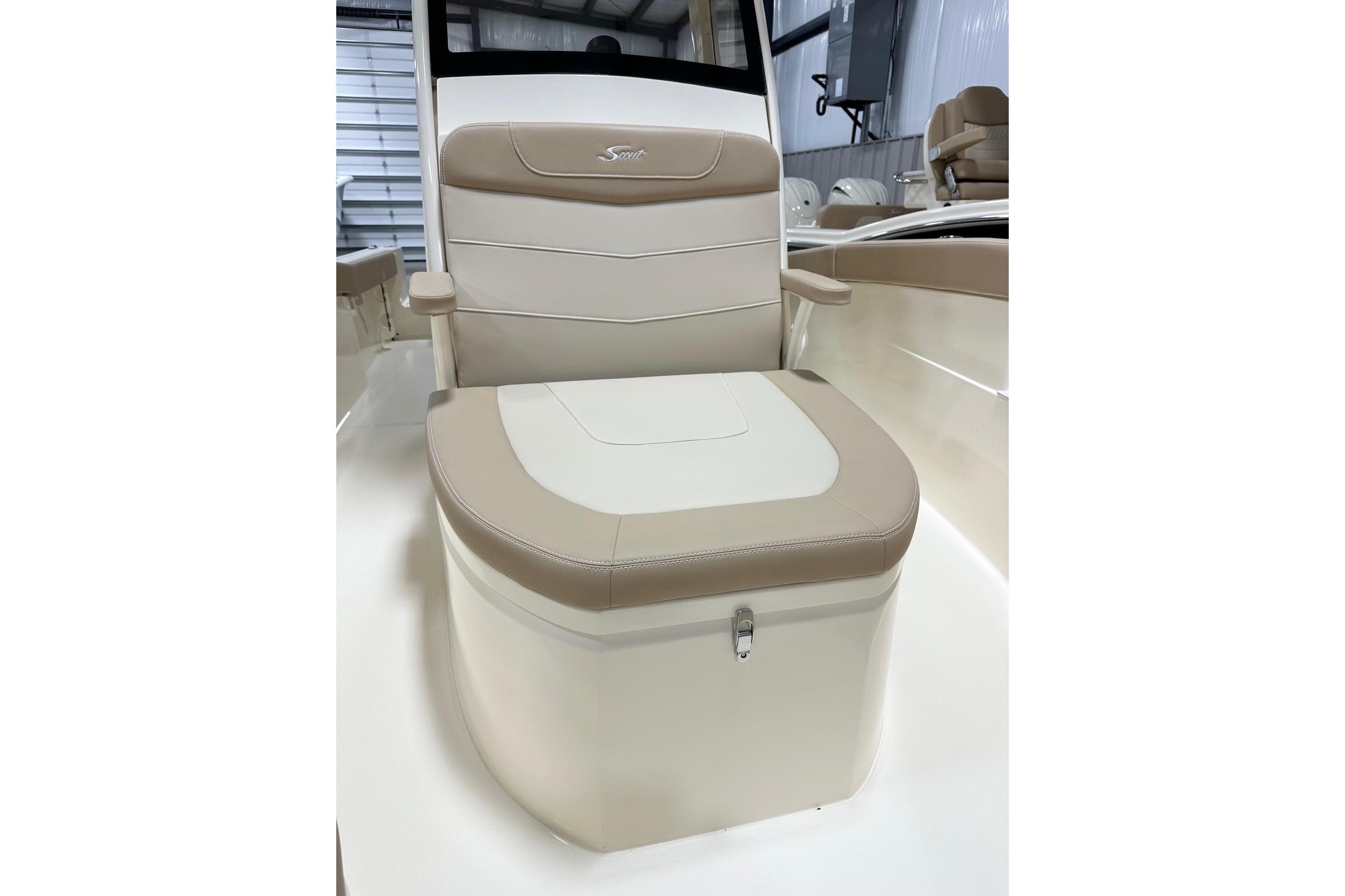 2026 Scout 240 XSF boat seat with beige and white upholstery in a showroom.