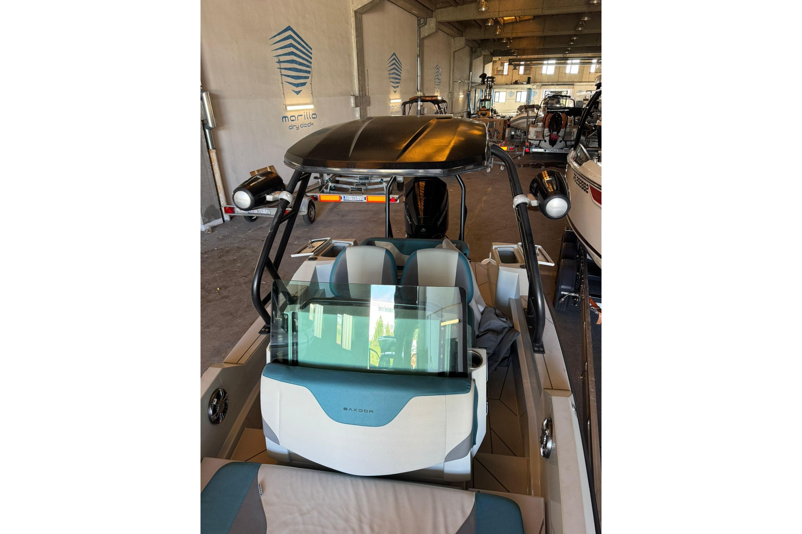 2021 Saxdor 200 boat in a showroom, featuring sleek design and modern seating.
