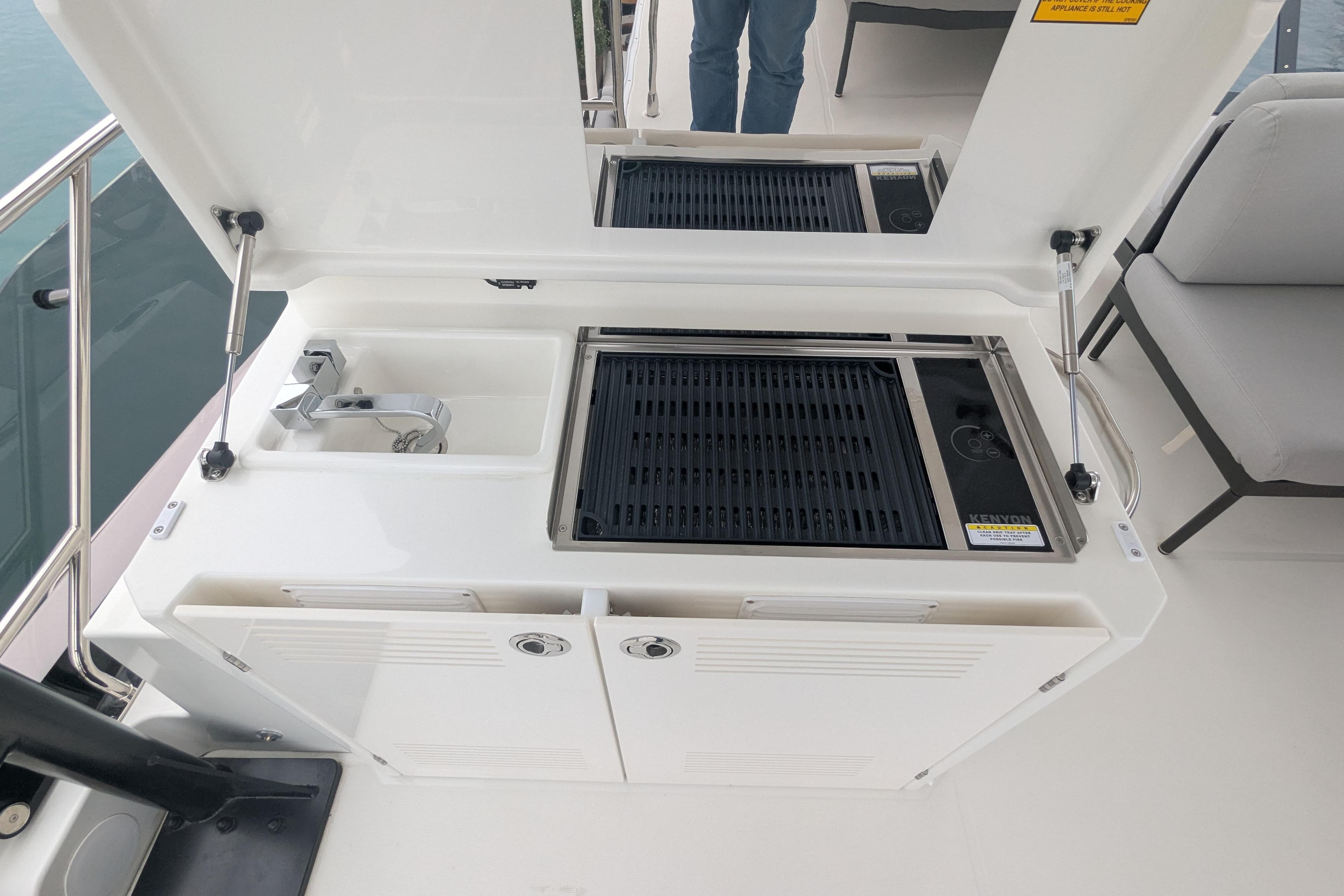 Outdoor kitchen on 2024 Prestige M48 yacht with grill and sink.