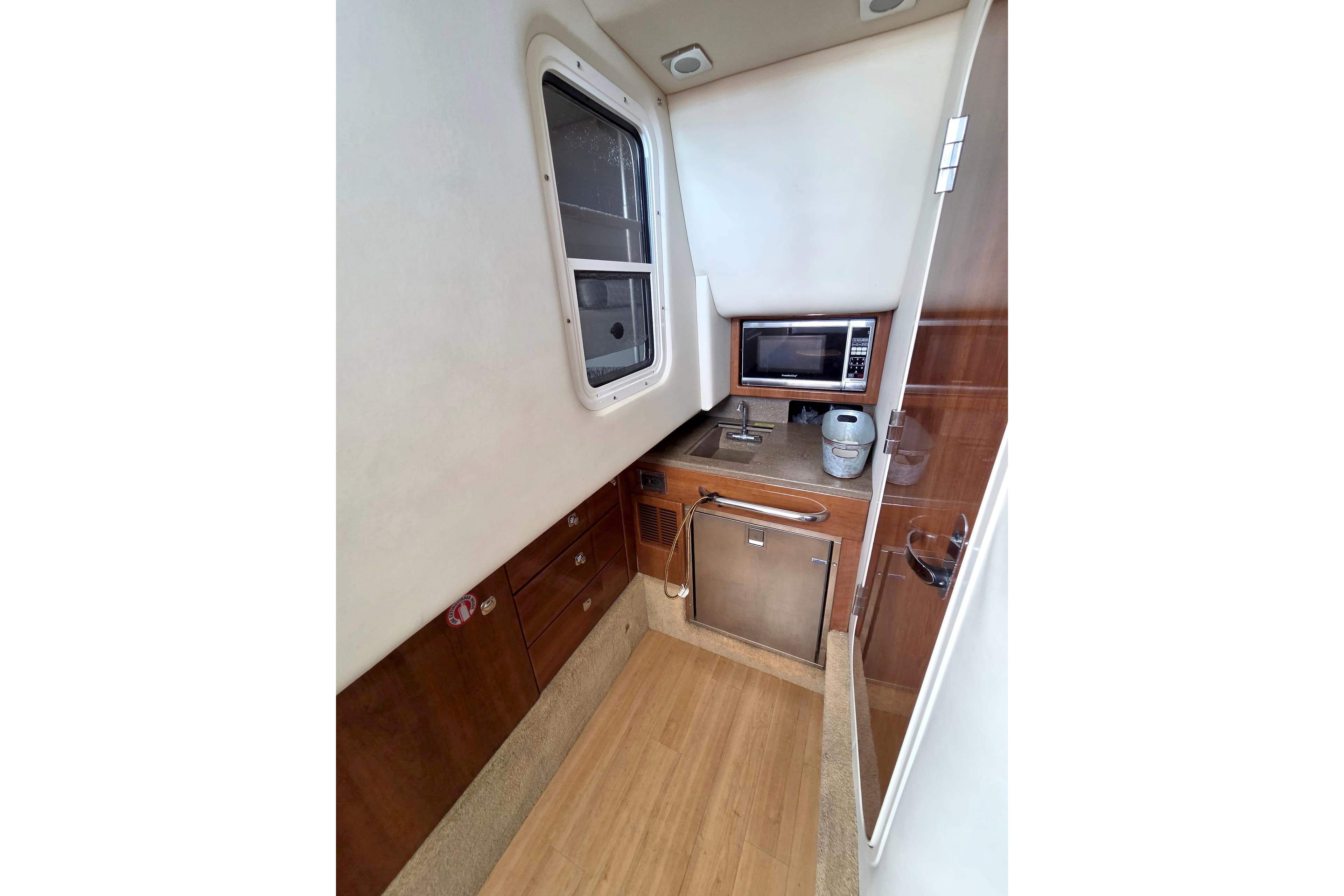 2015 Formula 350 Crossover Bowrider interior kitchen with microwave and sink.