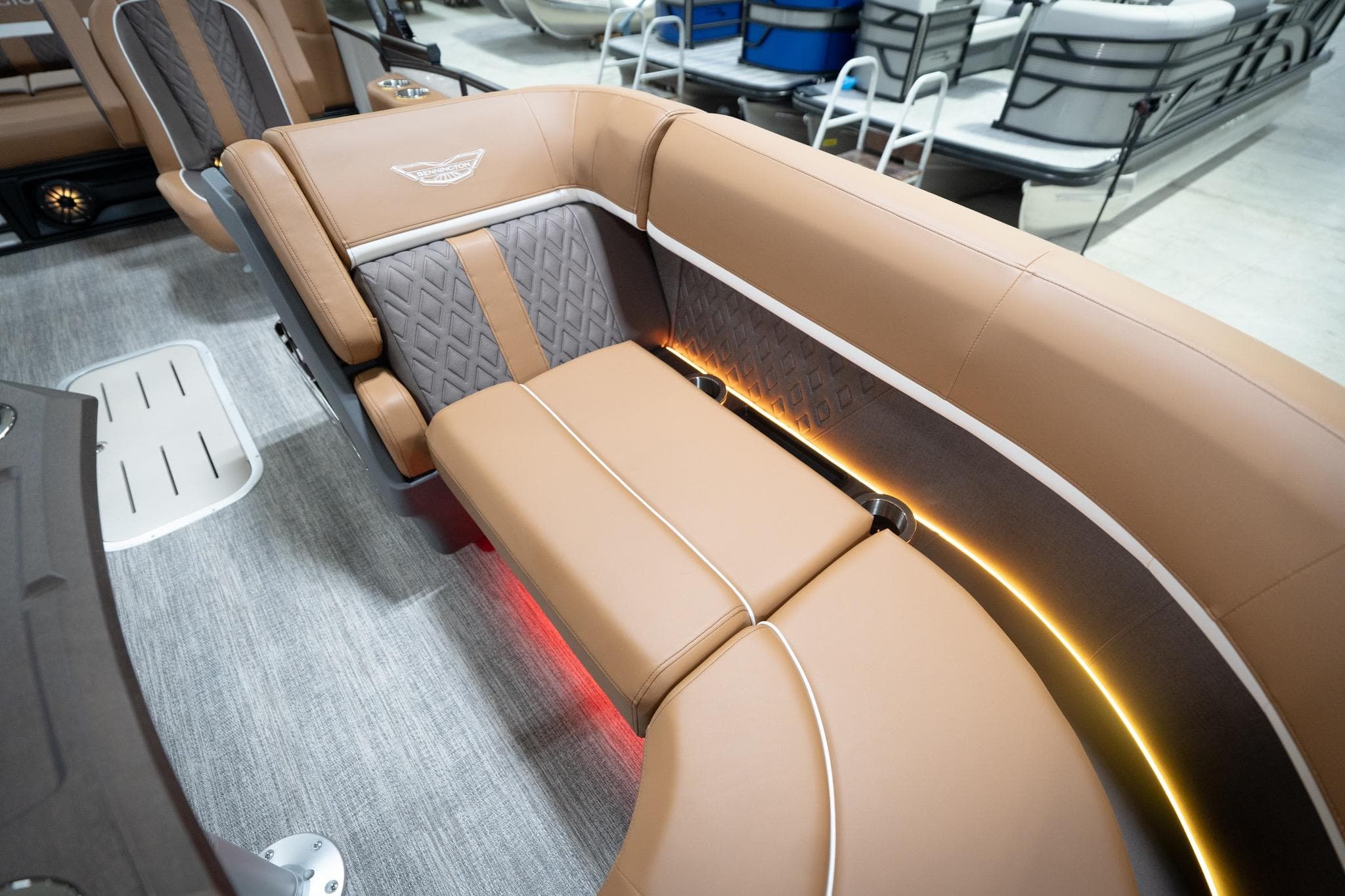2026 Bennington 22 MSB boat interior with luxurious tan seating and ambient lighting.