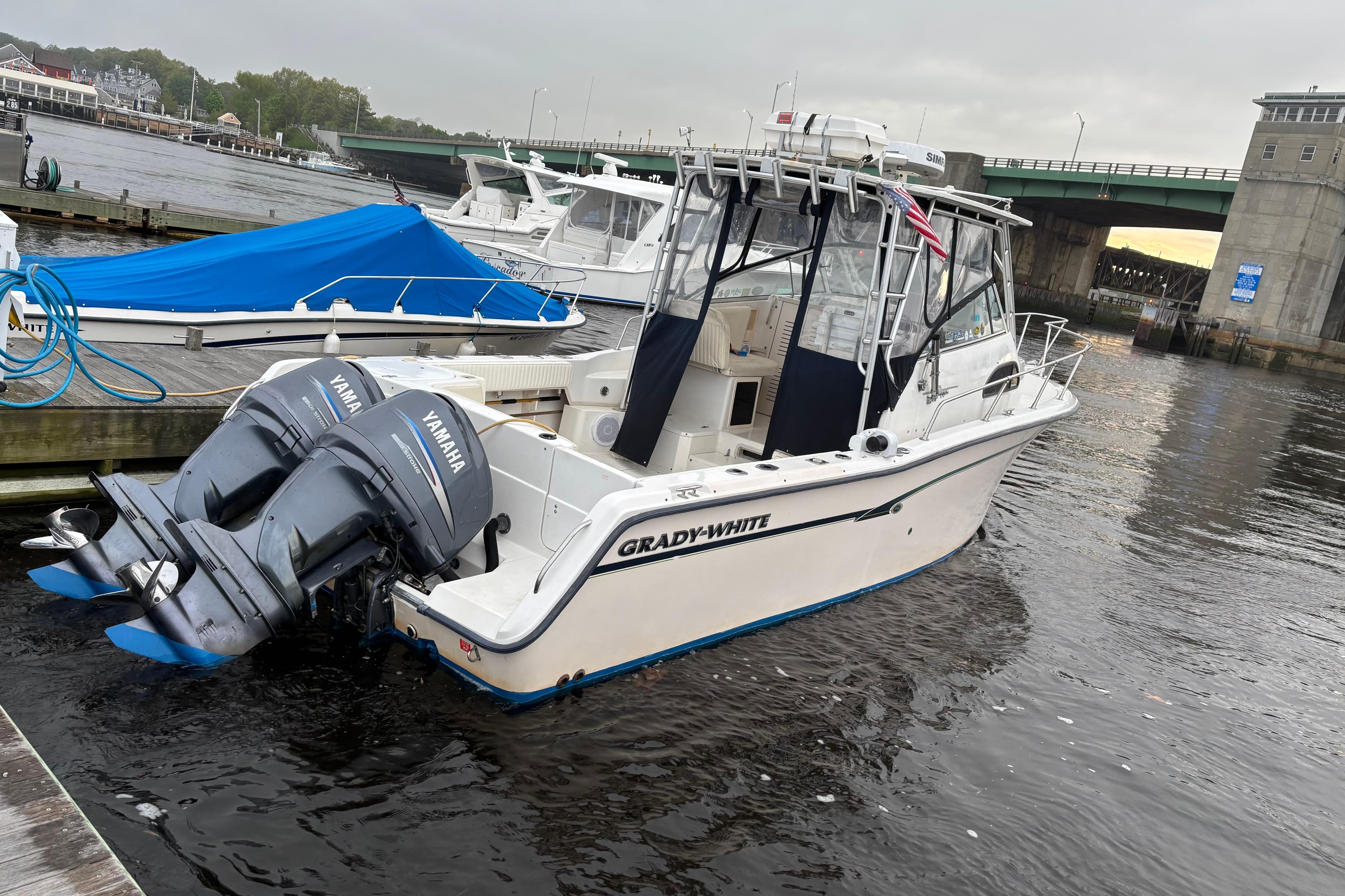 1999 Grady-White Marlin 300 boat docked with twin Yamaha outboard engines.
