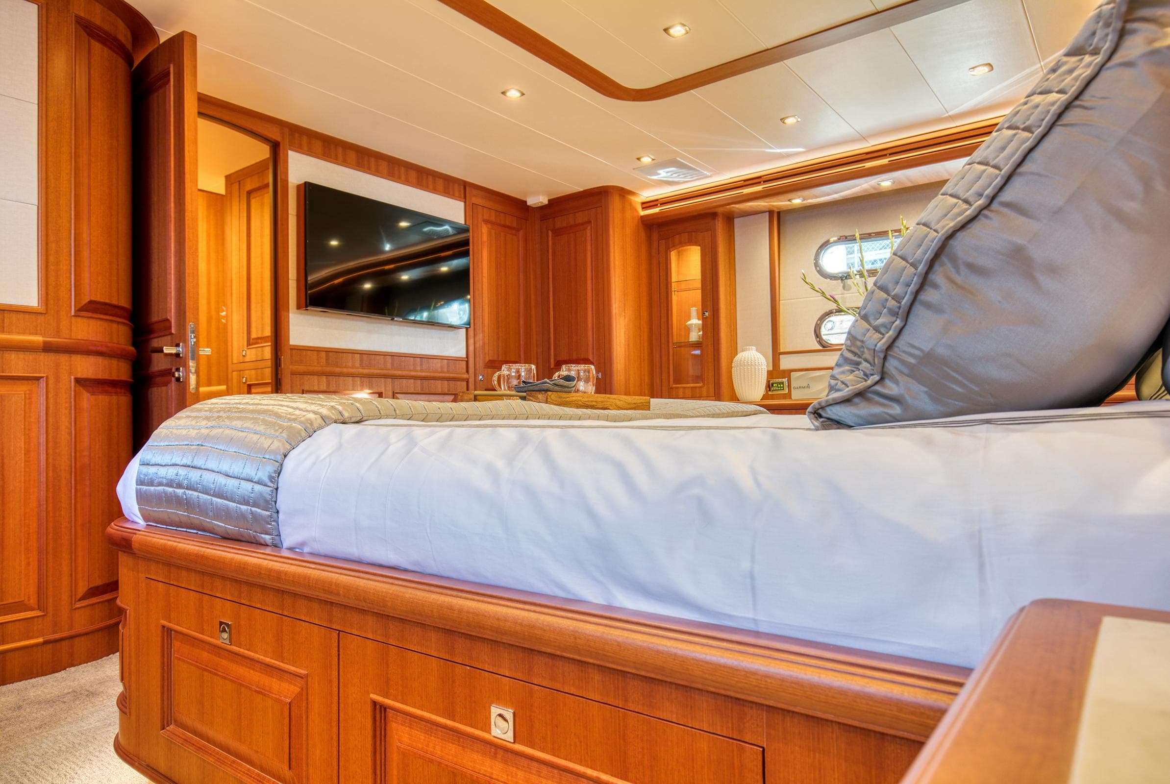 Luxurious bedroom interior of 2025 Hampton 750 Endurance LRC yacht, featuring elegant wood finishes.