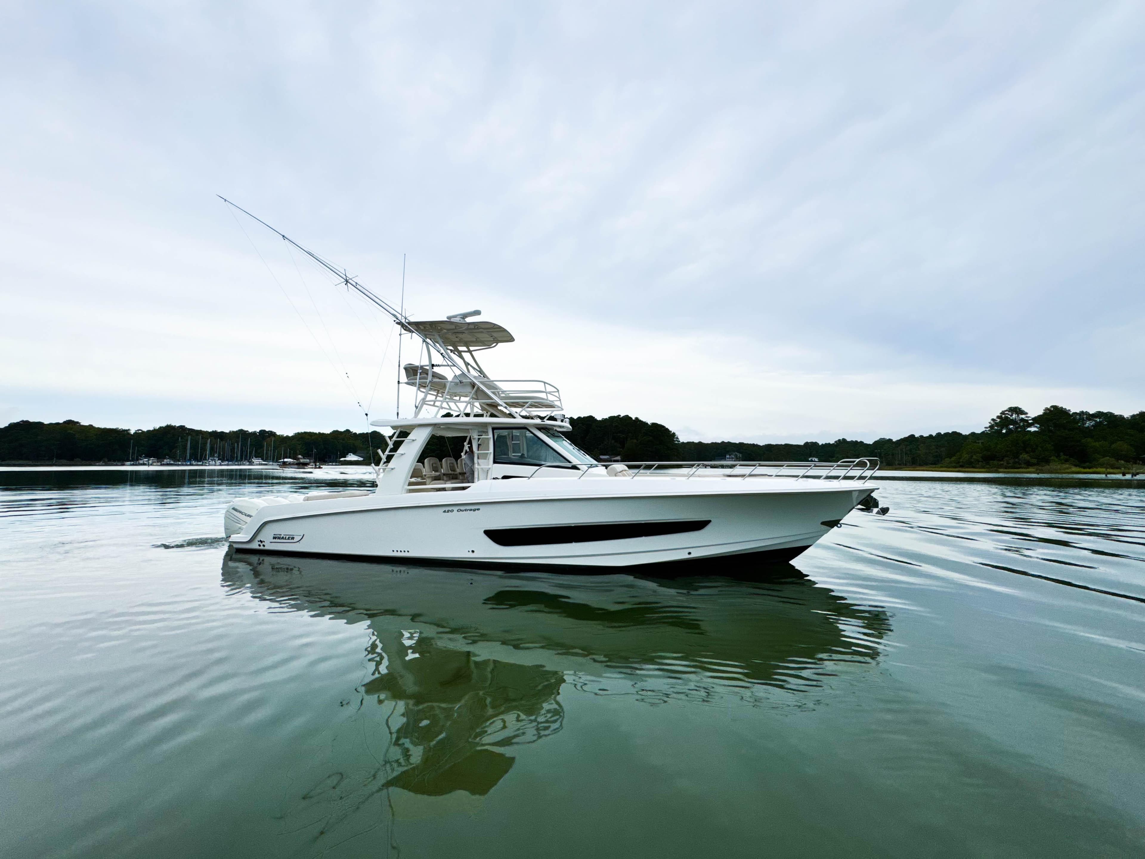 2017 Boston Whaler 420 Outrage boat on calm water, side view.