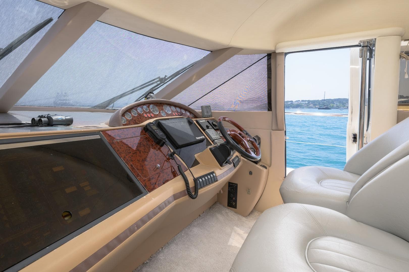 Interior view of a 2001 Princess 61 yacht cockpit with ocean backdrop.
