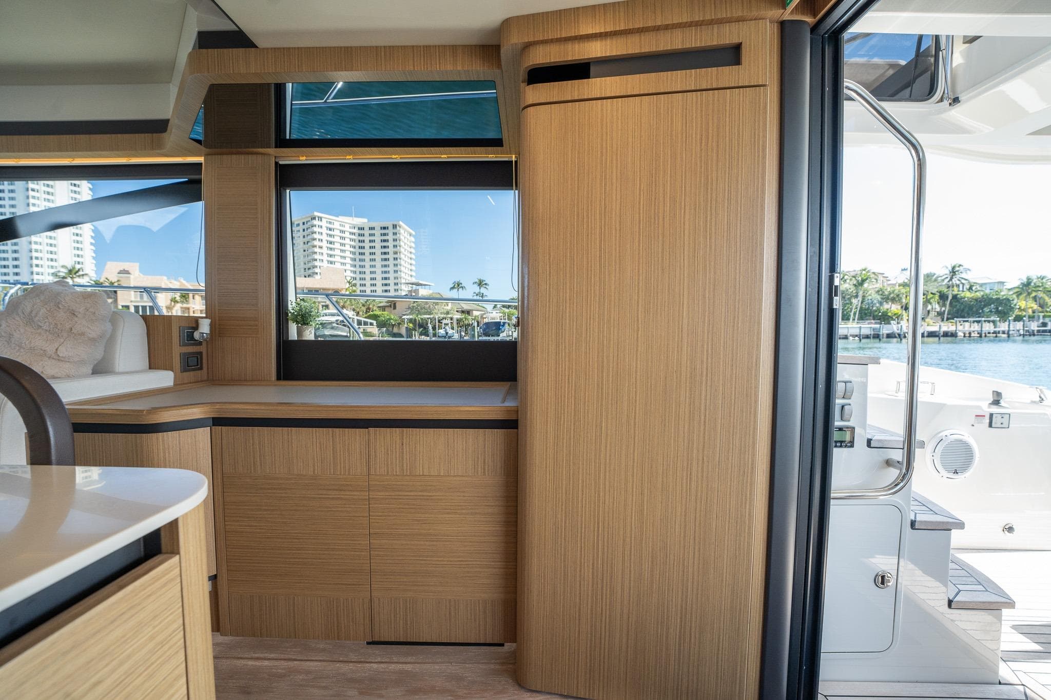 Interior of 2020 Absolute 50 Fly yacht with modern wood finish and waterfront view.