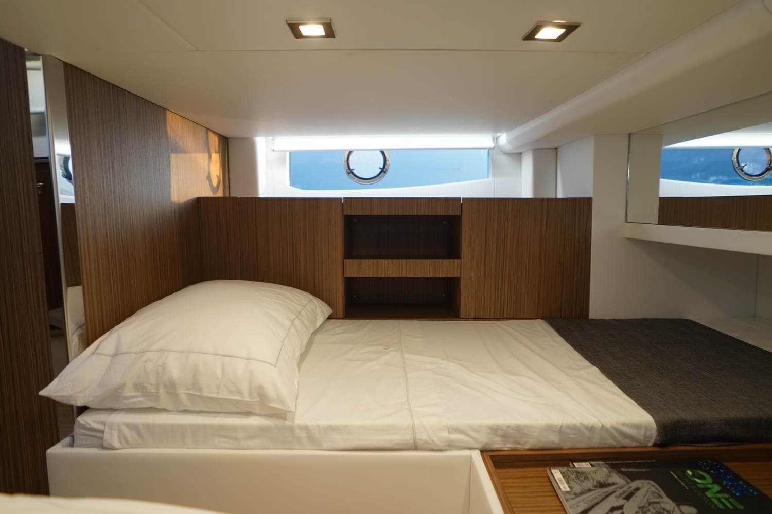 Luxurious cabin interior of 2023 FIM 340 REGINA yacht with modern wood paneling.