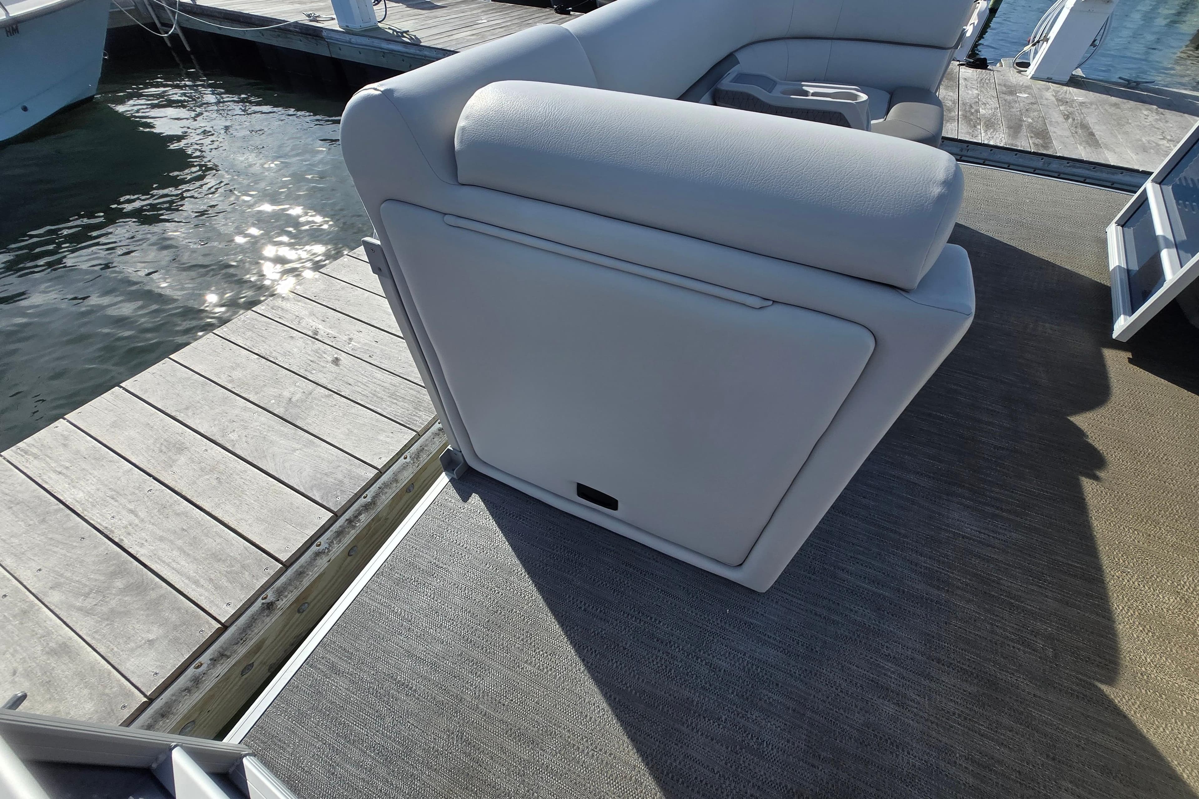 2023 Godfrey Sweetwater 2286 SBX pontoon boat with plush seating at dockside.
