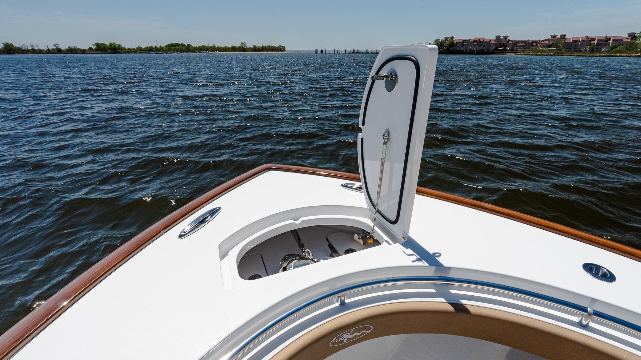 2025 Valhalla Boatworks V-29 Hybrid on water, open hatch, scenic view.
