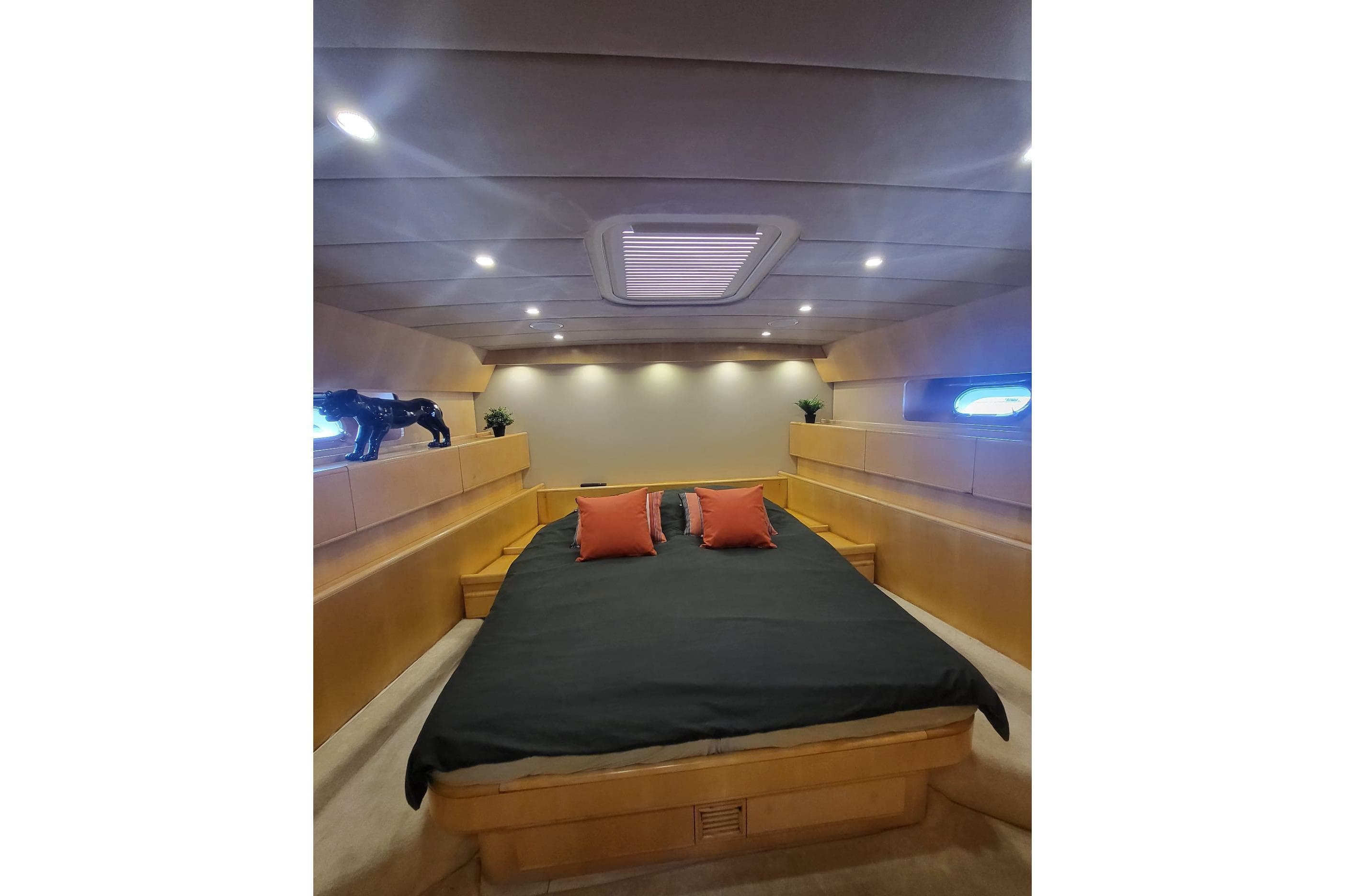 Luxurious bedroom interior of 1999 Arno Leopard 23 yacht with modern lighting and decor.