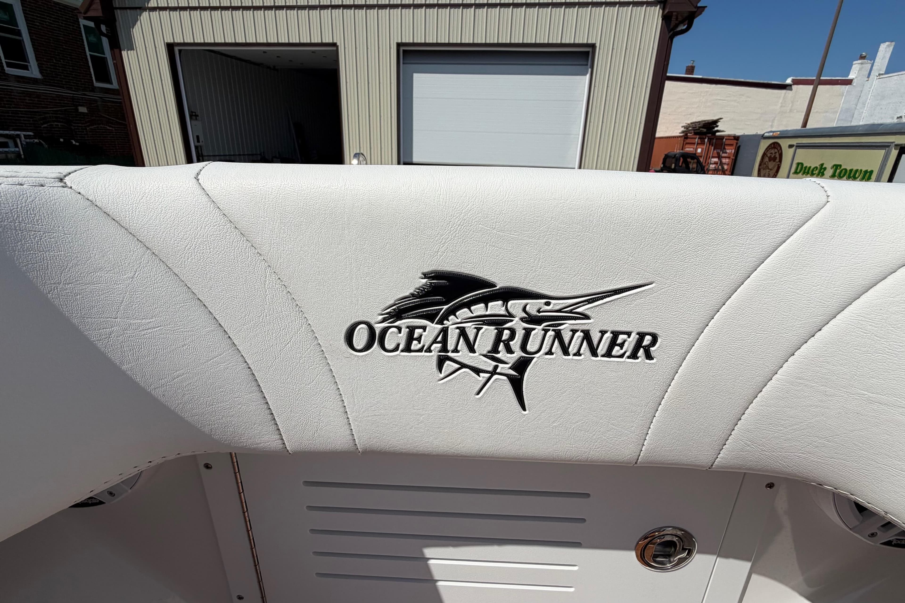 2023 Ocean Runner 2 boat seat with logo in a sunny outdoor setting.