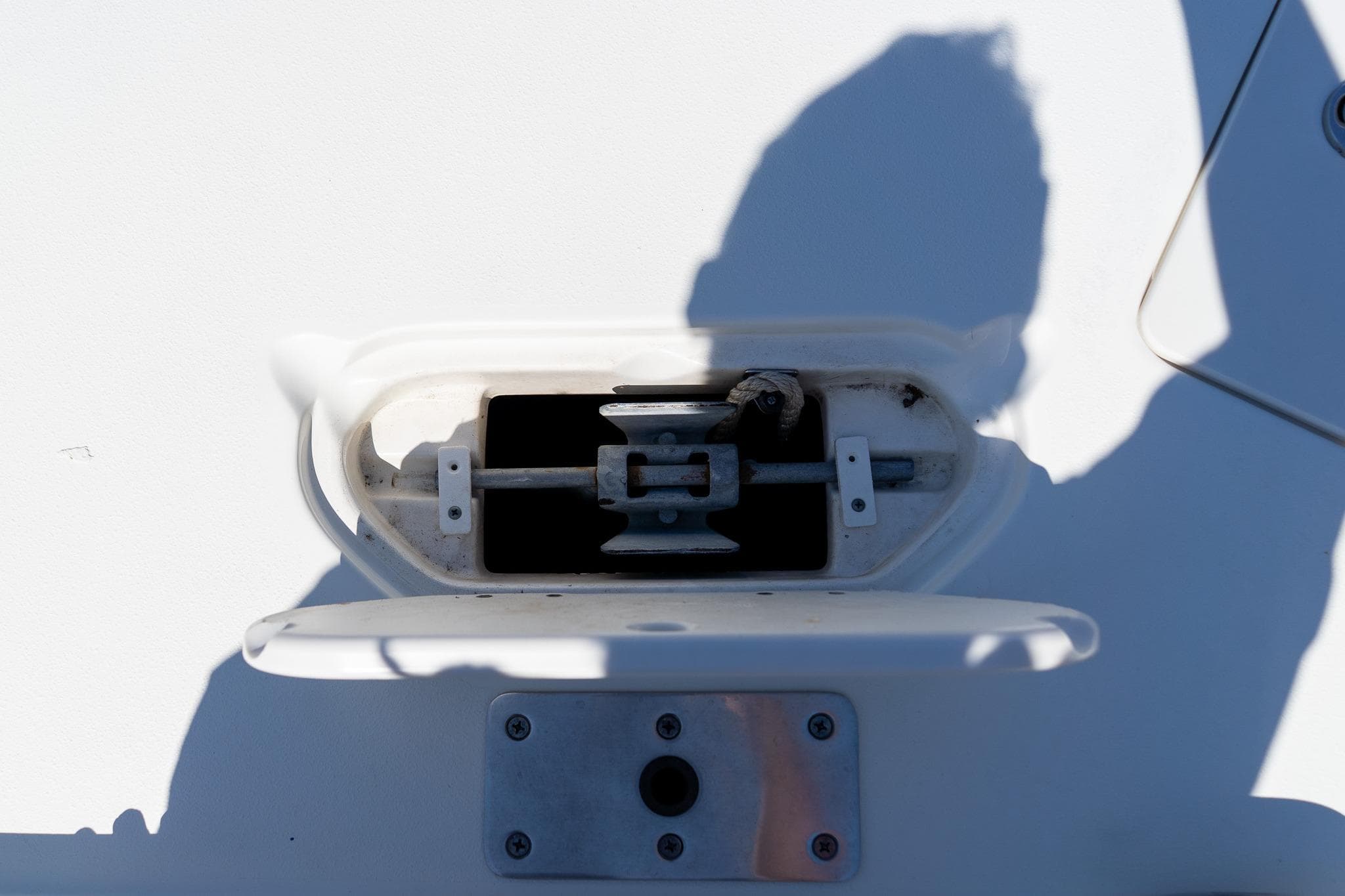 Hatch on 2020 NauticStar 203 SC boat with shadow cast on surface.